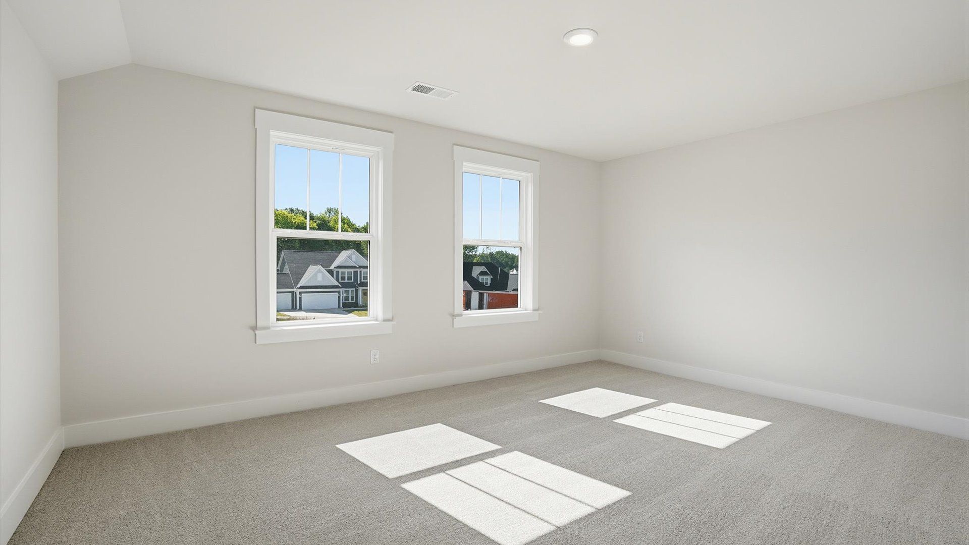 Highly functional bedroom with large windows, carpeted flooring, and tasteful finishes throughout at the Pinebrook community