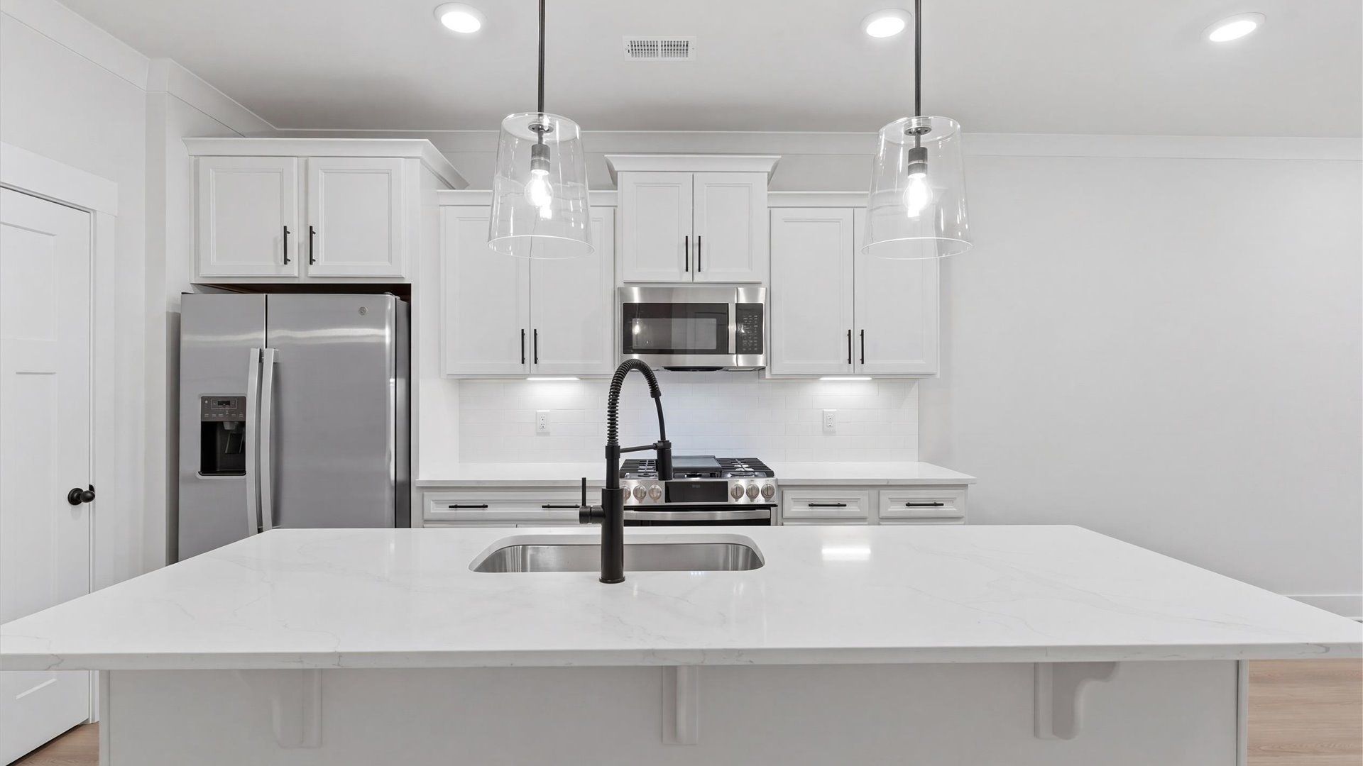 Notable kitchen space with elegant pendant lighting and a large island perfect for entertaining located in Greenville, SC