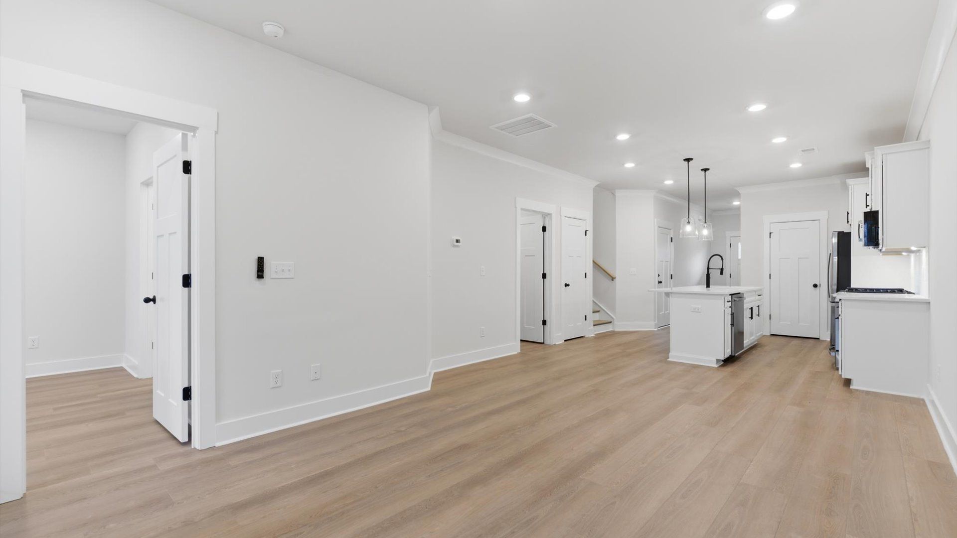 Hardwood flooring and high standards define this vibrant family room ideal for everyday living at Pelham Crossing