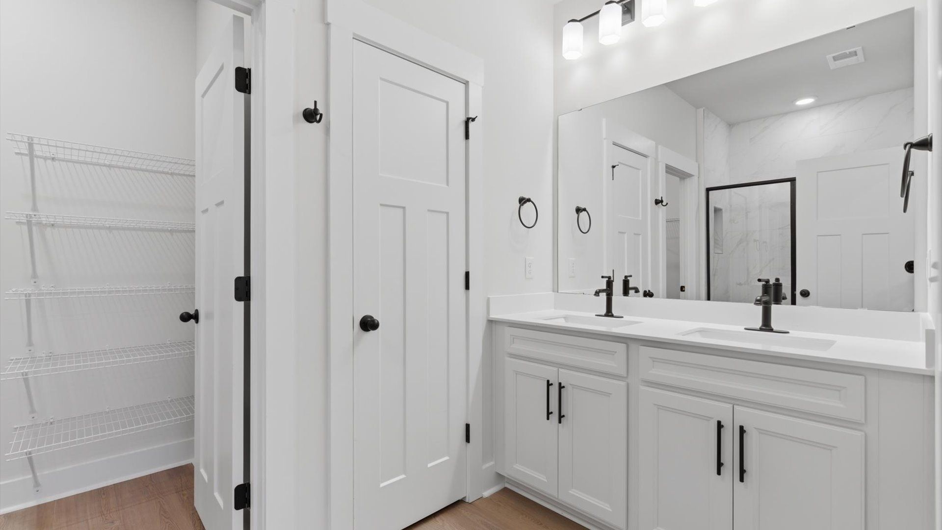 Exceptional en-suite with dual vanity and glass-enclosed walk-in shower for superior everyday comfort at Pelham Crossing