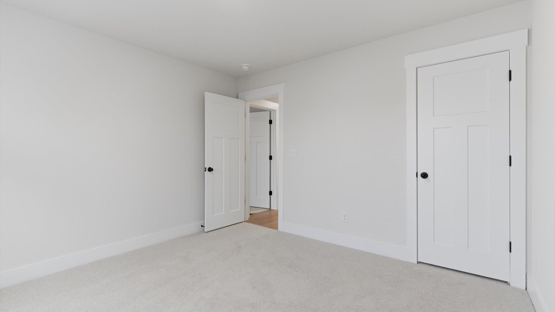 First-rate secondary bedroom with a spacious walk-in closet and elegant carpeted flooring at Pelham Crossing