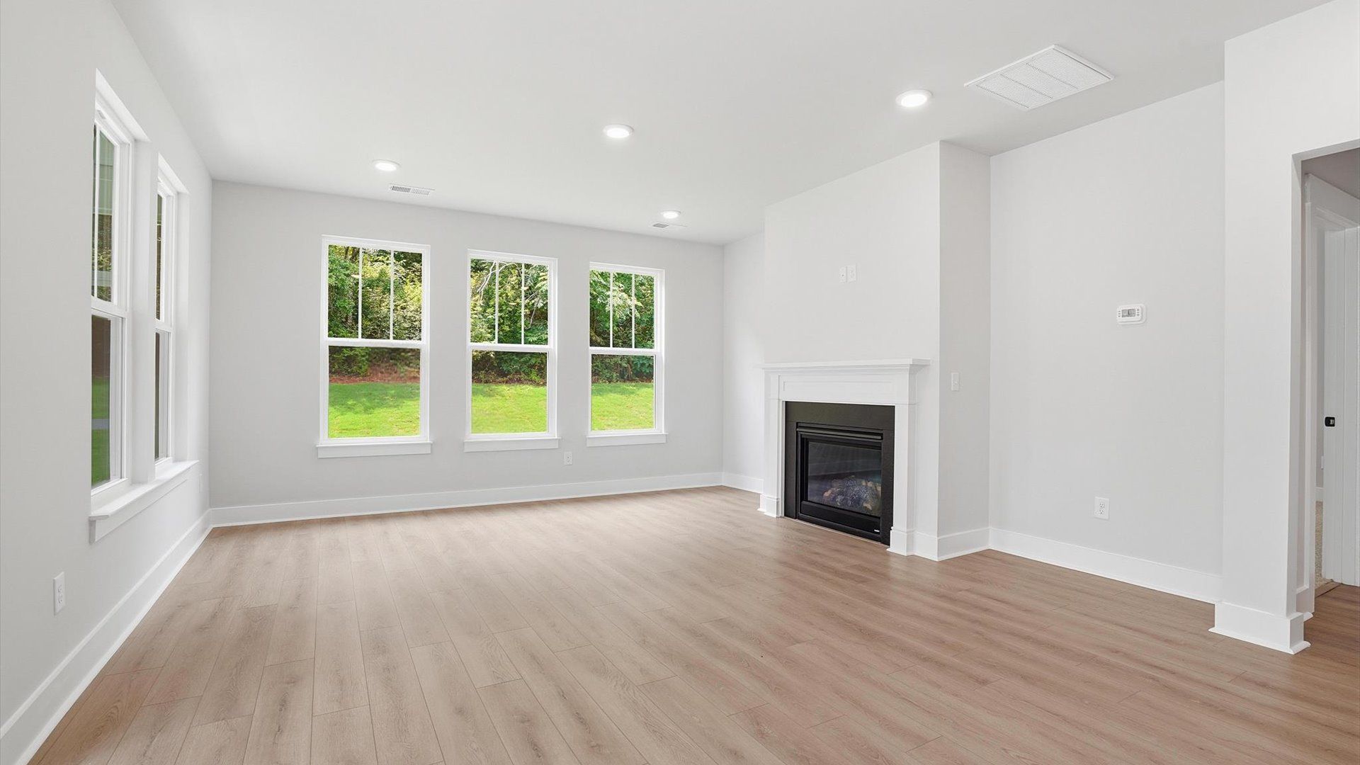 Highly skilled craftsmanship and modern elegance meet in this family room with soaring ceilings near Lake Hartwell