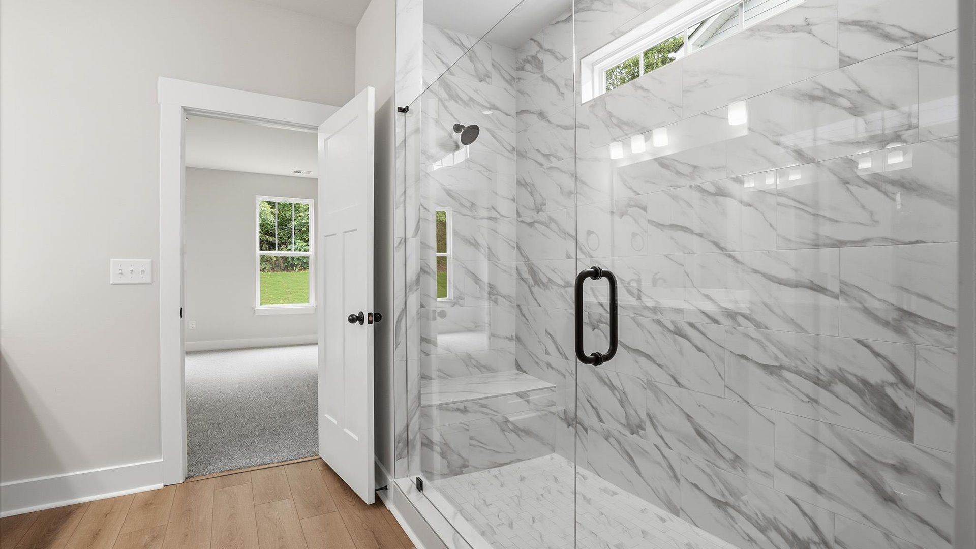 Exceptional en-suite with natural light and a glass-enclosed walk-in shower for superior everyday comfort