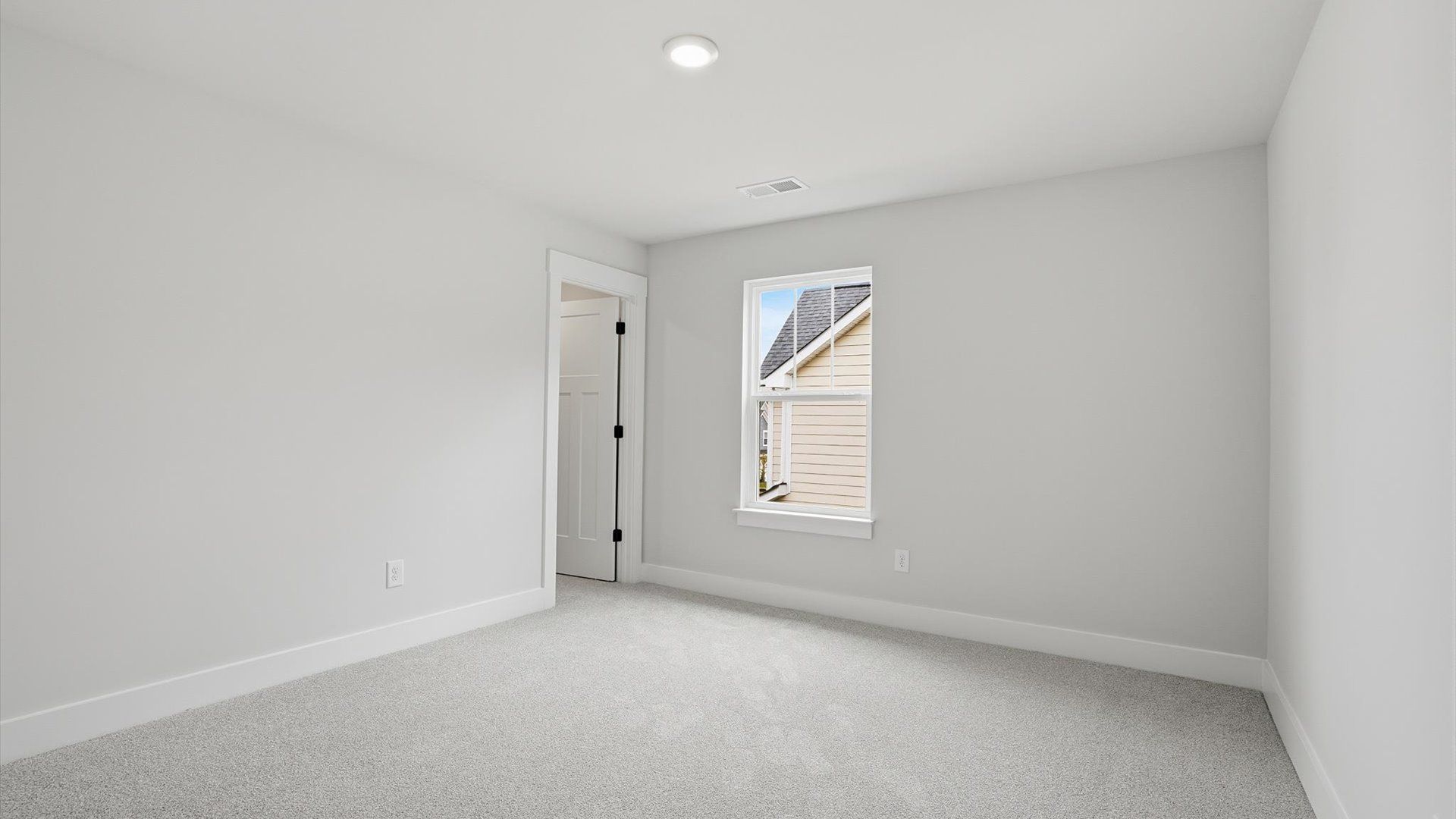 Refined bedroom design with a large window for daylight-filled mornings and peaceful views located at Creeks at Midway
