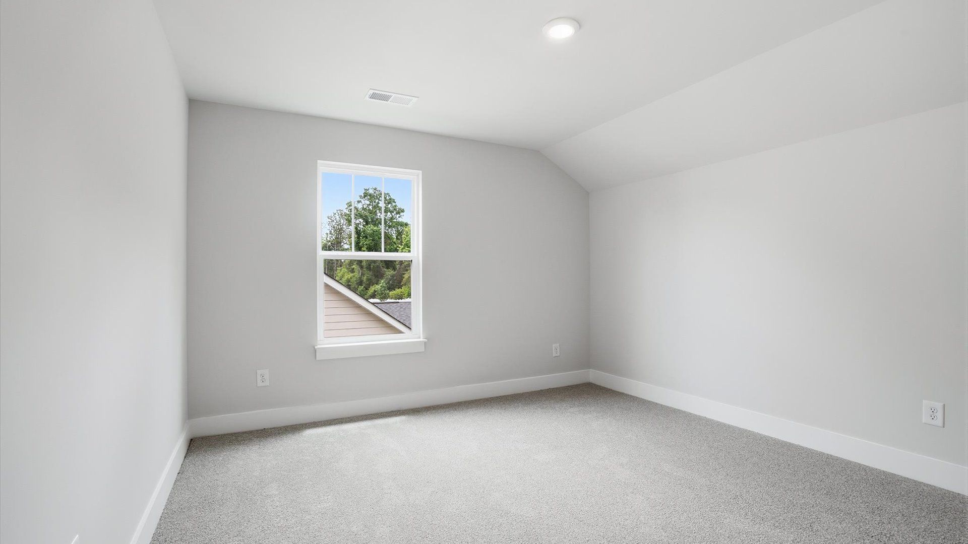 Inviting bedroom with tasteful finishes and a large window that creates a fresh, open ambiance located near Downtown Anderson