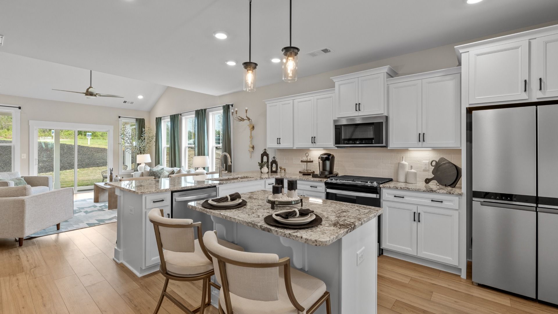 Vibrant and open kitchen centered around a center island with elegant pendant lighting above located in Fountain Inn, SC