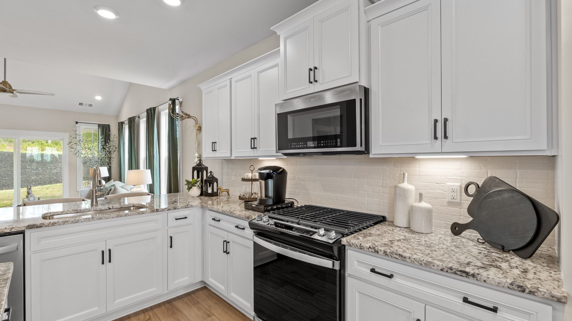 Superior kitchen with granite countertops, stainless steel appliances, and white cabinets in Fountain Inn, SC