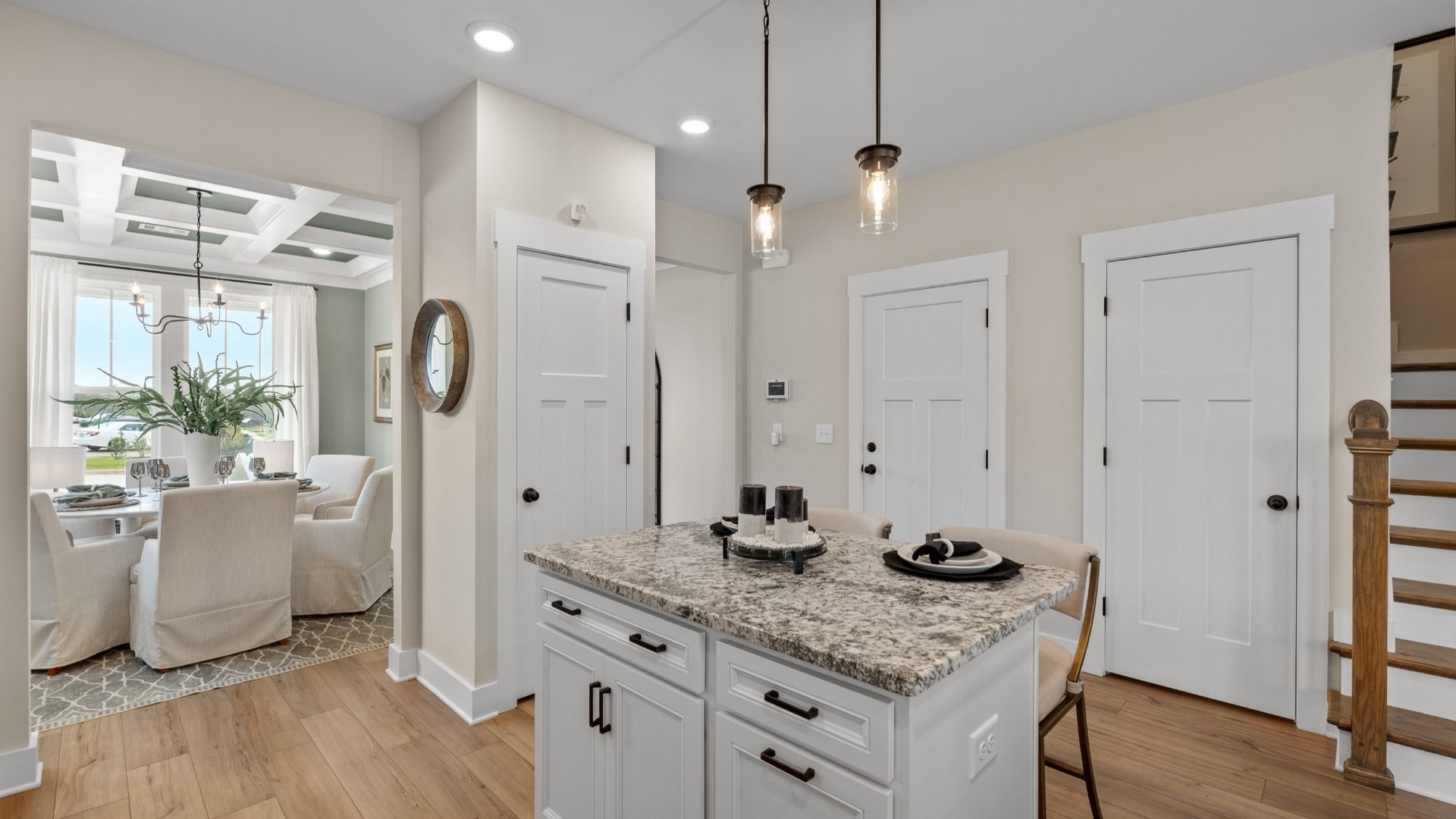 Highly skilled craftsmanship shines in this modern kitchen with pendant lighting and a central island focal point