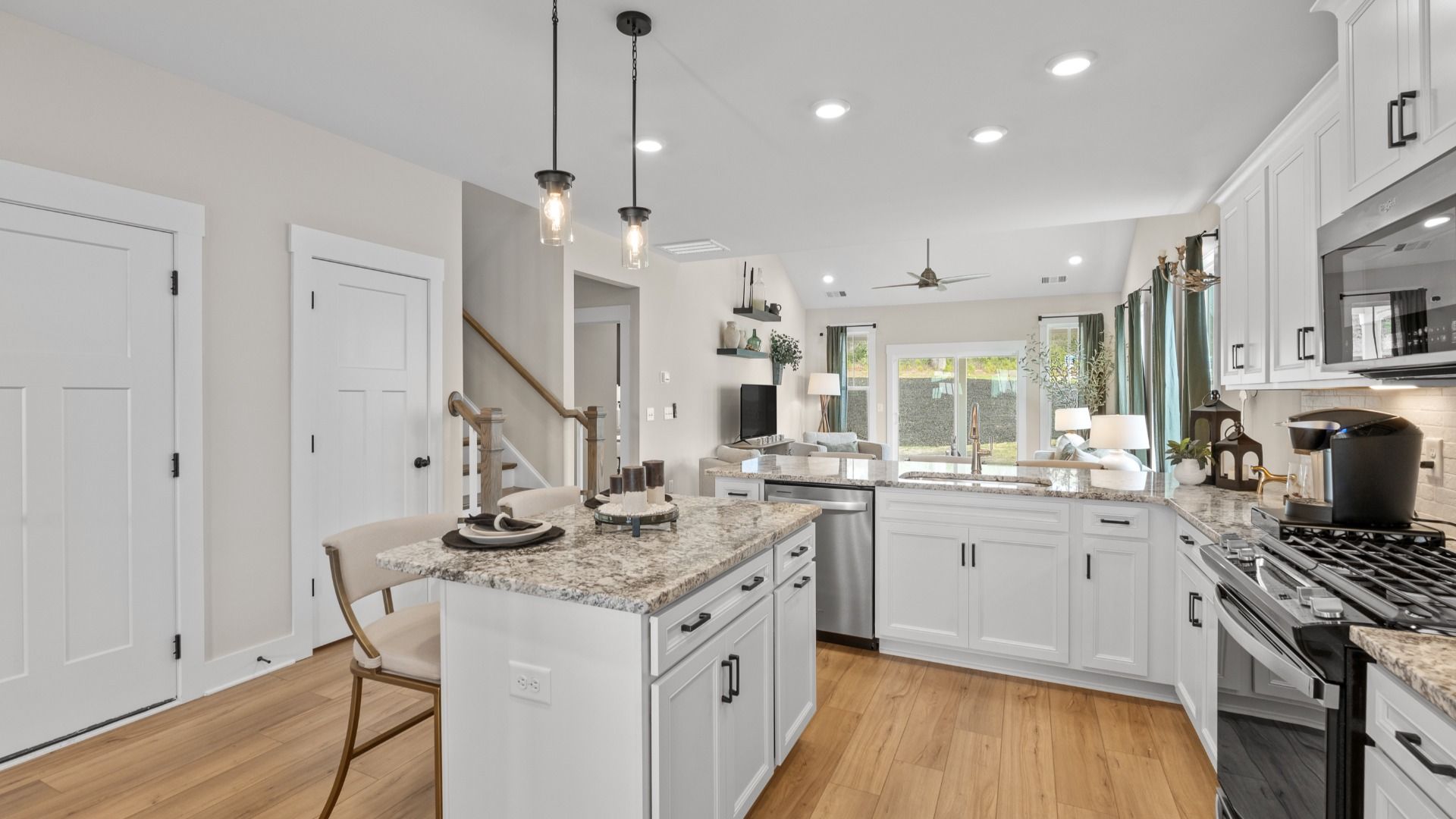 Superior craftsmanship shines in this modern kitchen with a space-saving island and open flow at Barton Hollow