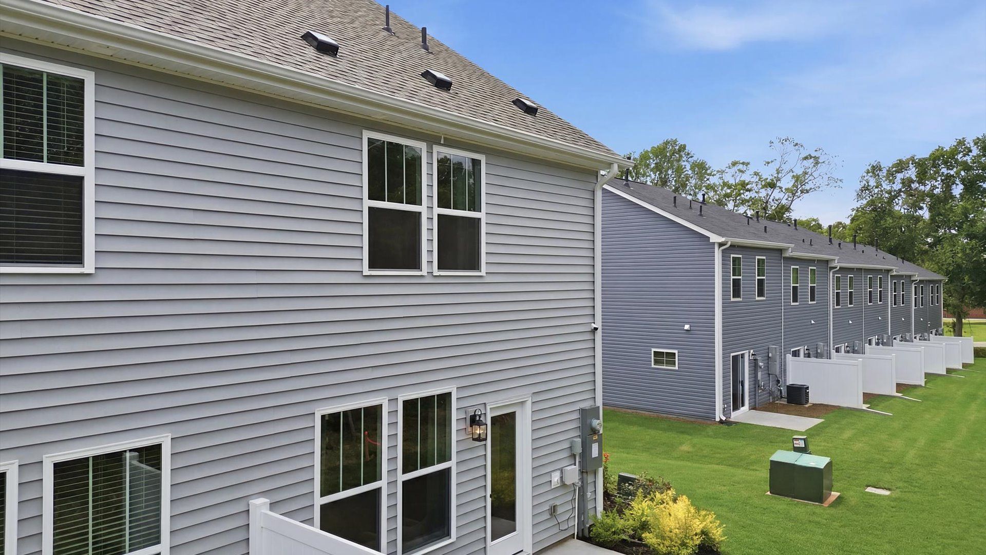 Rear backyard creates a seamless extension of this home’s elegant design at Clarke Townes