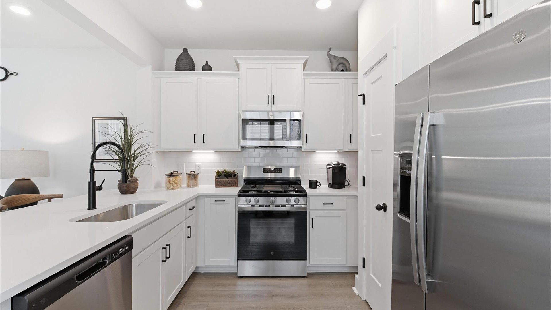 Tasteful kitchen with quartz countertops and modern finishes in a first-class DRB Homes design