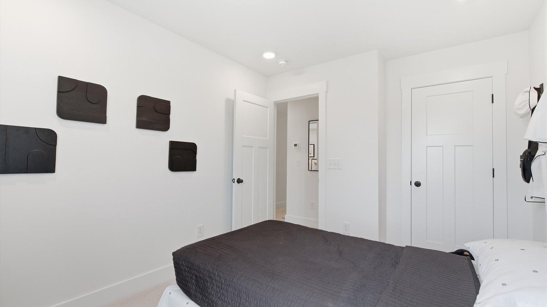 Superior comfort in a secondary bedroom with plush carpet and an oversized walk-in closet at the Churchill Design