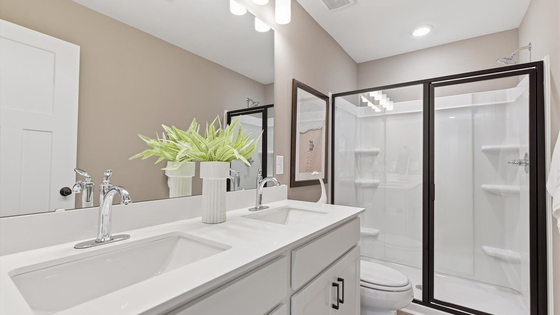 Notable primary suite with dual vanities and walk-in shower in this prime Anderson villa