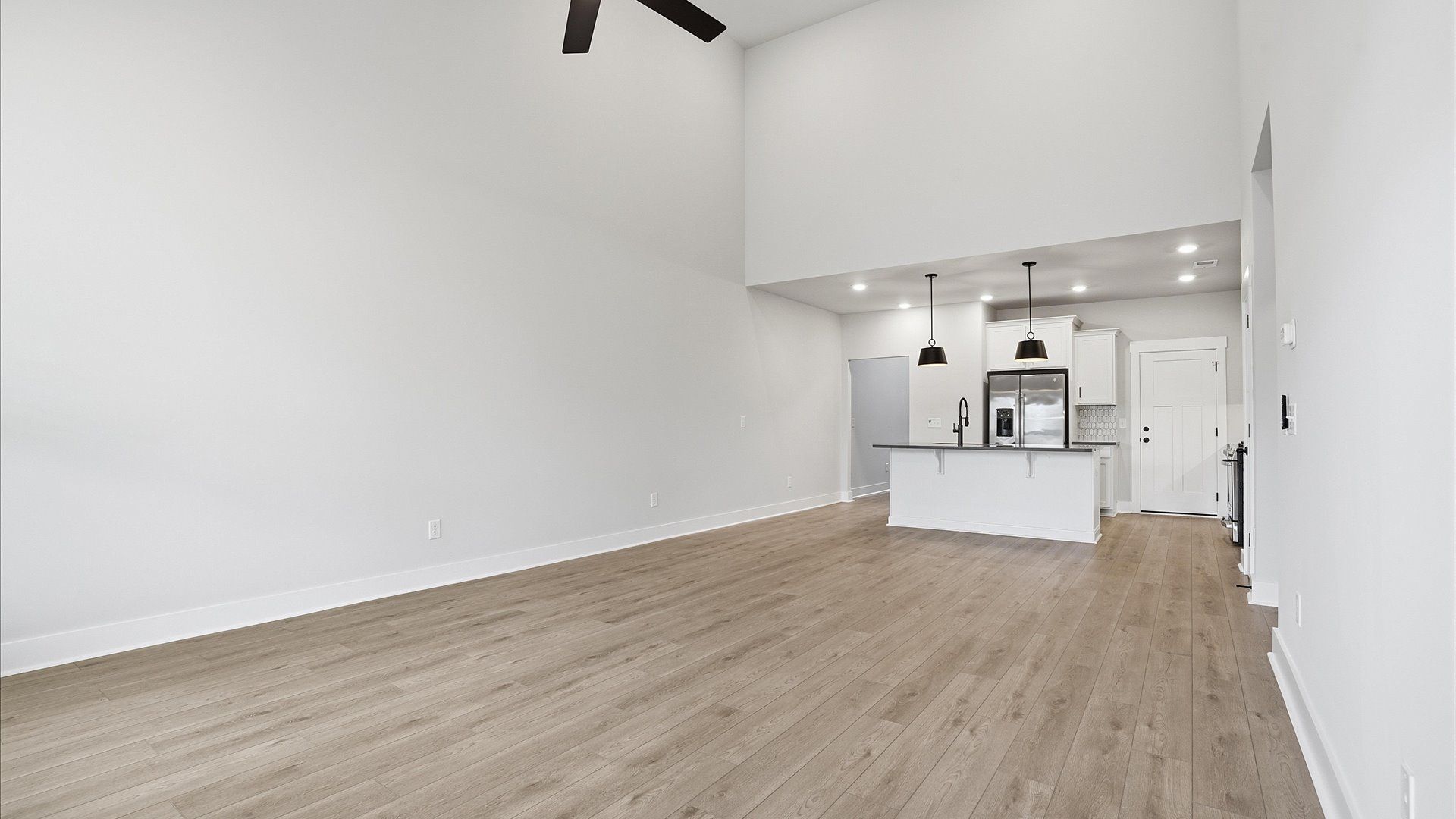 Accomplished design shines in this vibrant family room with dramatic two-story ceilings and open-concept flow