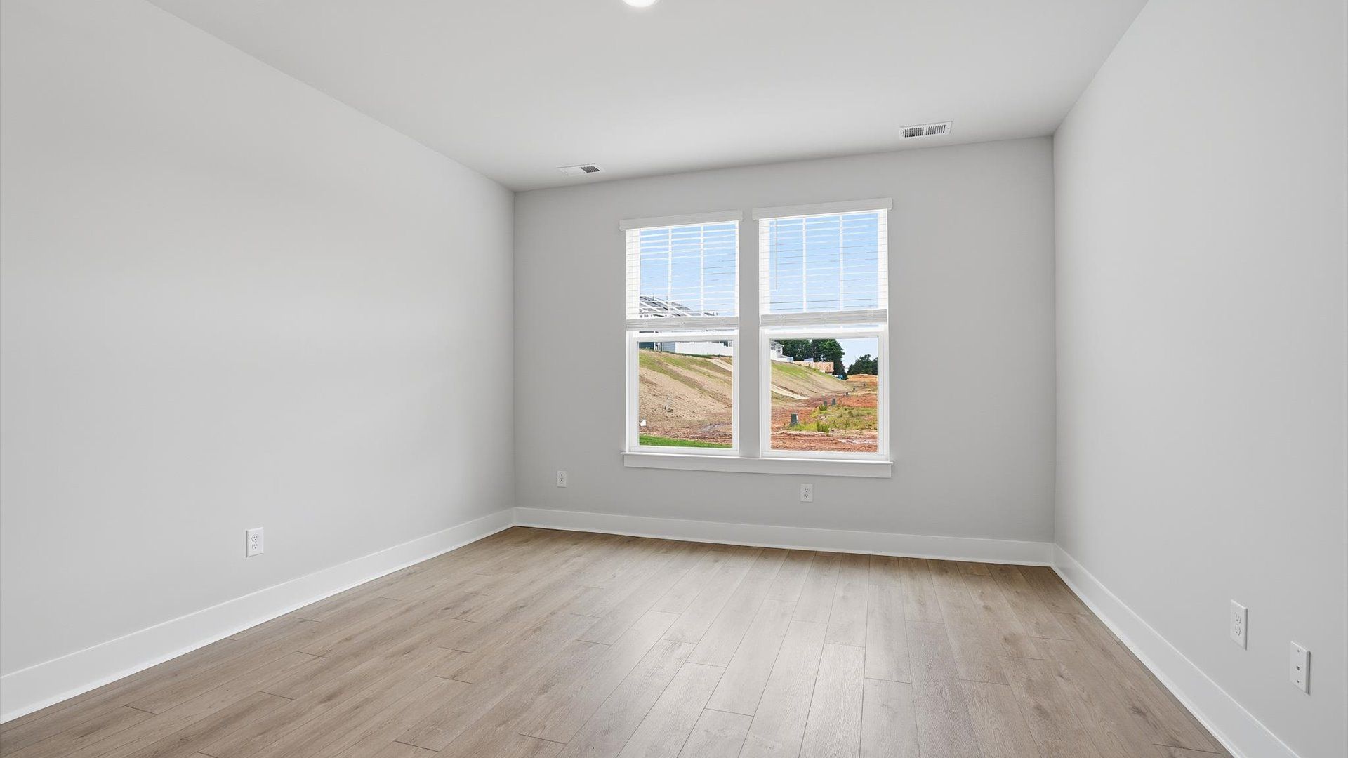 First-class hardwood floors and tasteful finishes elevate the private retreat of this exceptional primary suite in Anderson
