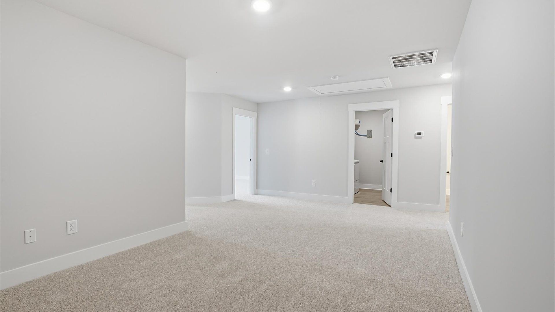 Inviting loft with cozy carpet, perfect for casual gatherings or quiet relaxation by DRB Homes