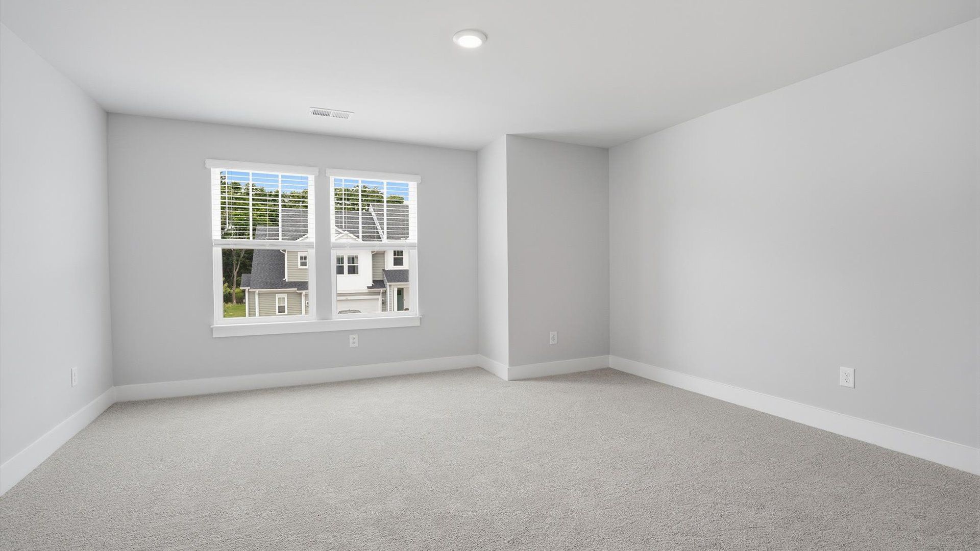 Elegant bedroom retreat featuring soft carpet and oversized windows that create a bright, welcoming space in Anderson, SC