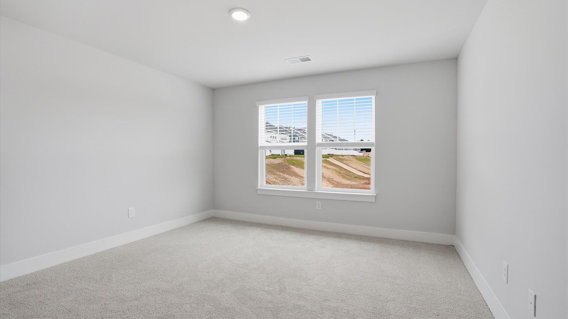 Bright and serene bedroom with comfortable carpeted flooring and large windows for vibrant light at Silo Ridge