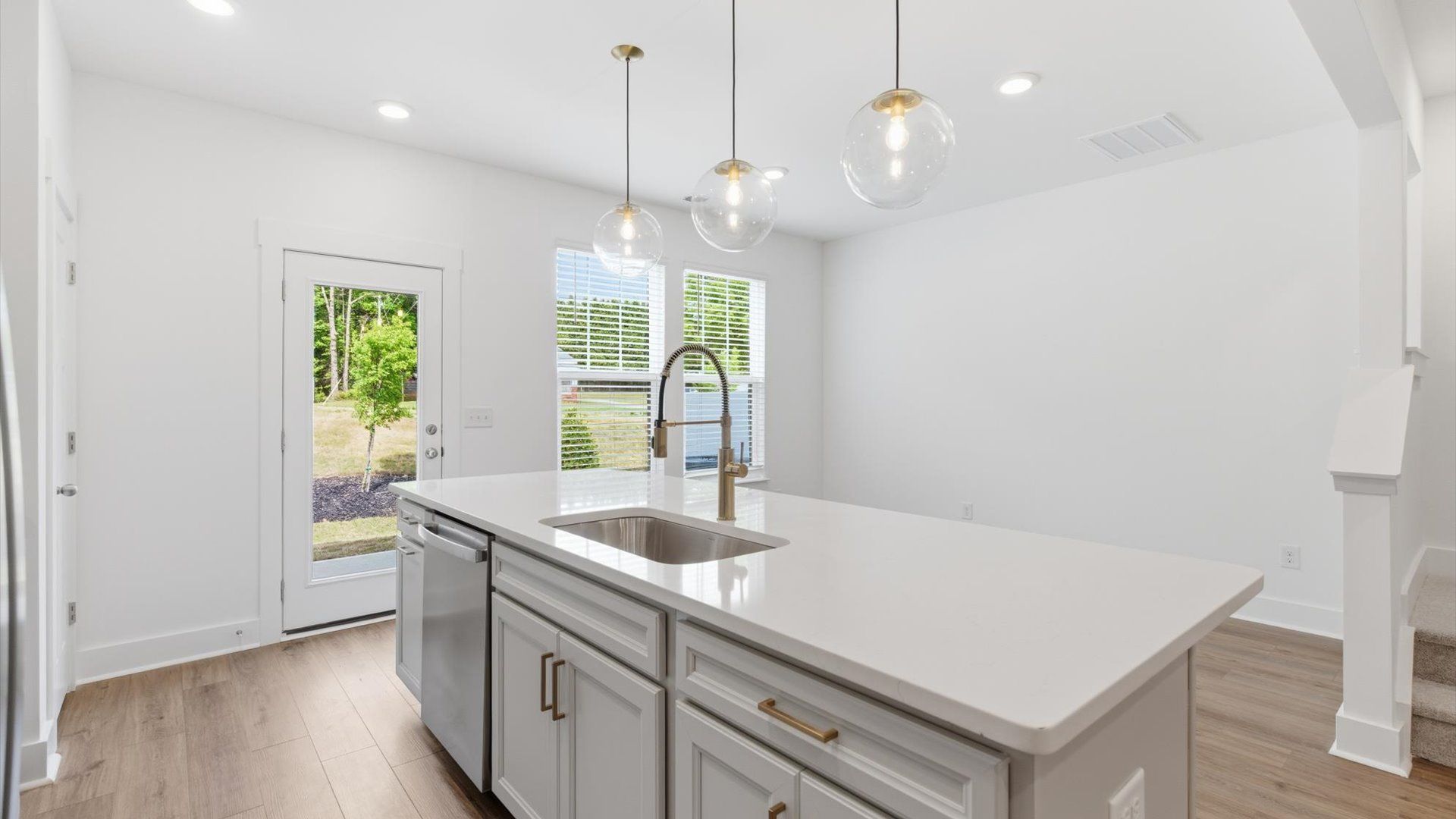 First-class kitchen with a spacious island—perfect for entertaining beneath designer pendant lighting in Simpsonville, SC