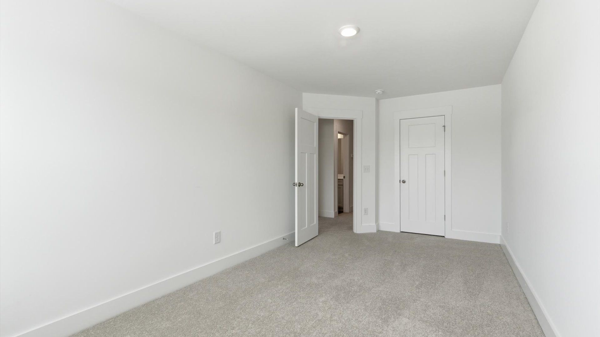 Highly functional bedroom with walk-in closet and tasteful carpet for a restful retreat at the Gresham Station community