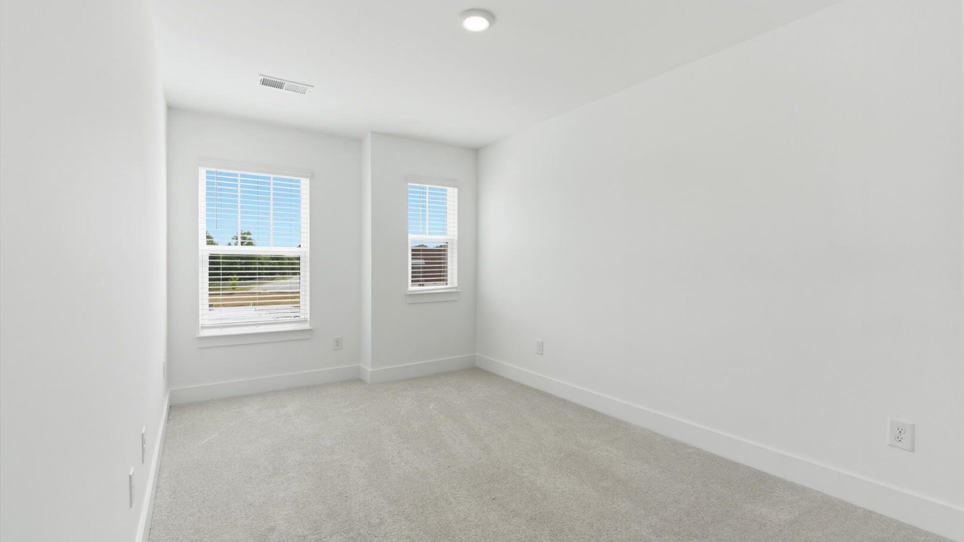 Refined bedroom design with large windows for daylight-filled mornings and peaceful views at Gresham Station