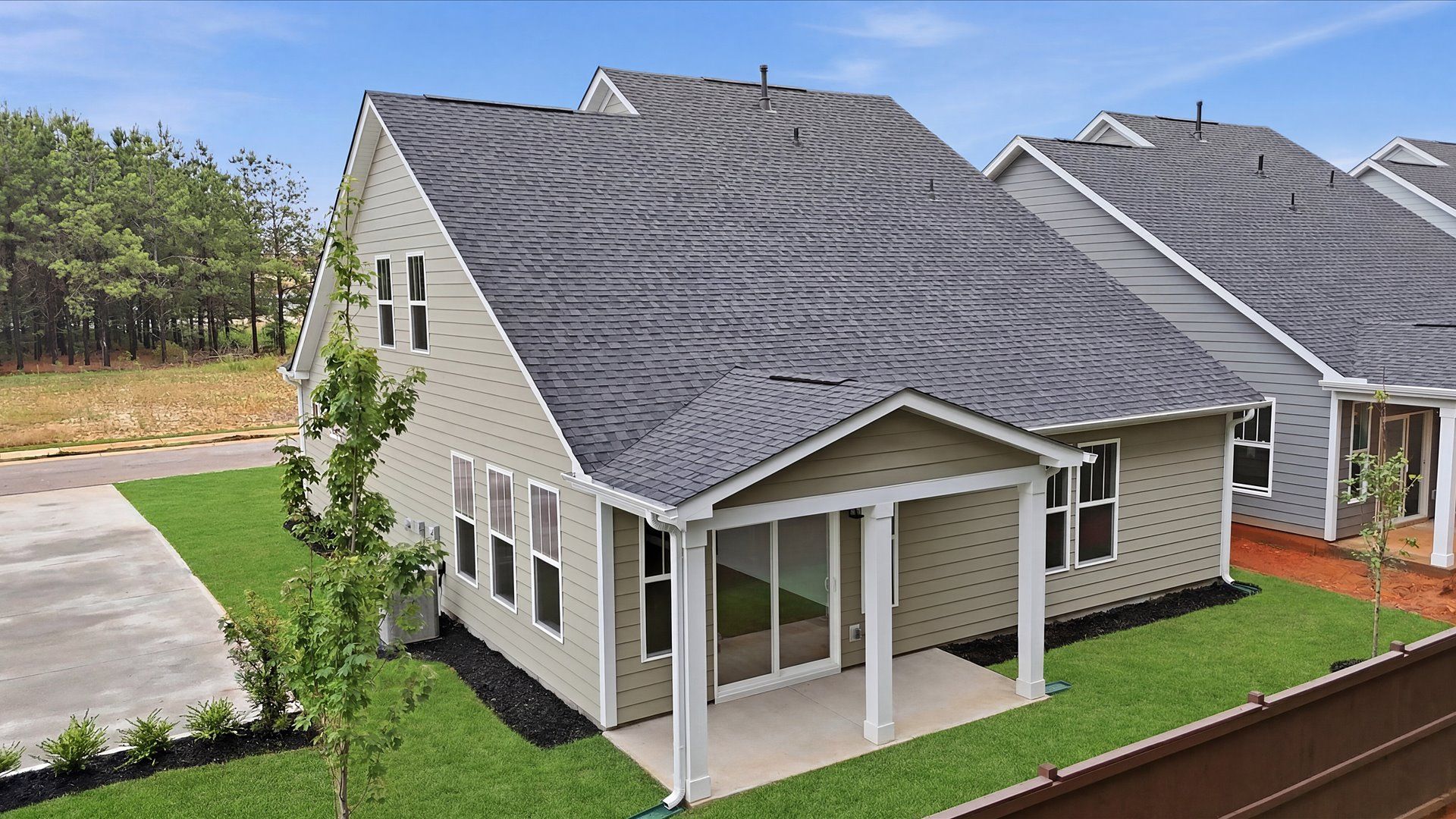 Warm and inviting outdoor living space with a covered rear porch and tasteful finishes at the new Barton Hollow community