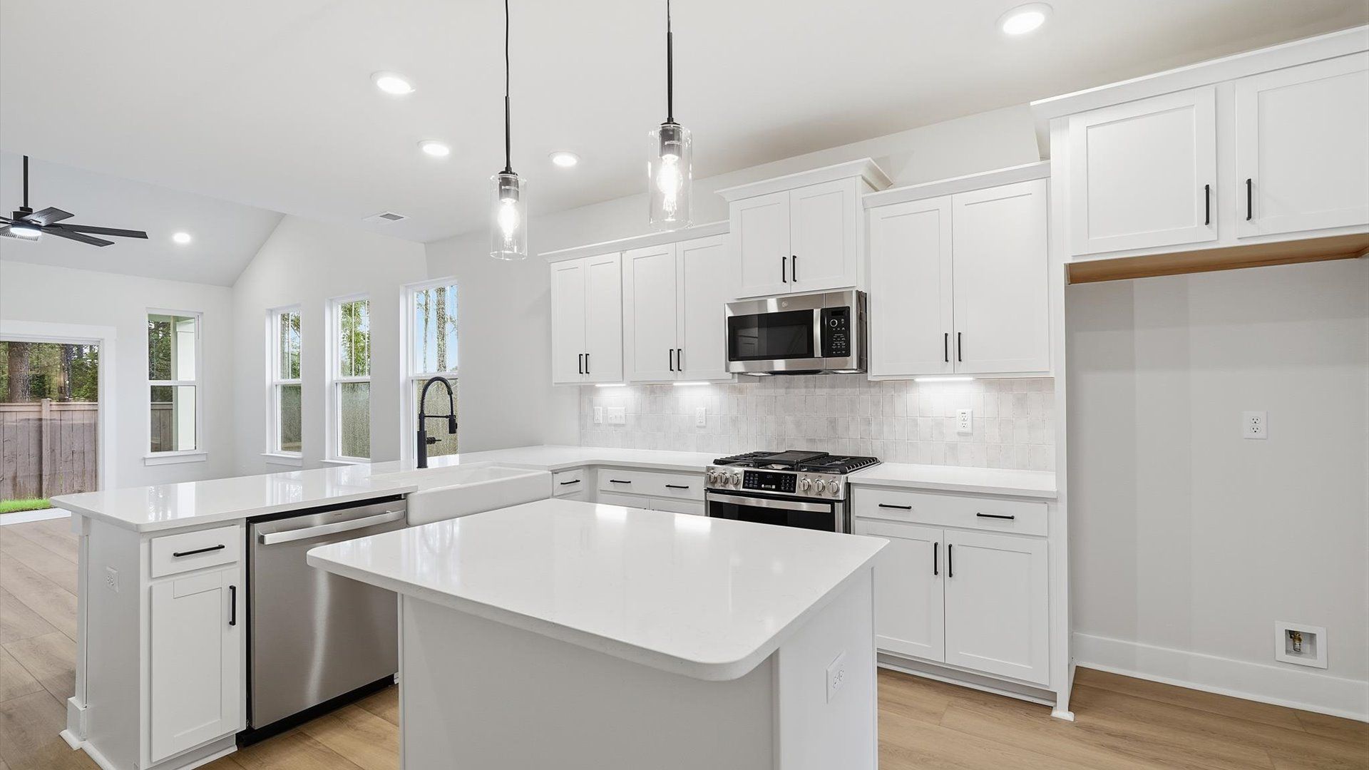 Superior craftsmanship shines in this modern kitchen with a space-saving island and open flow at the Barton Hollow community