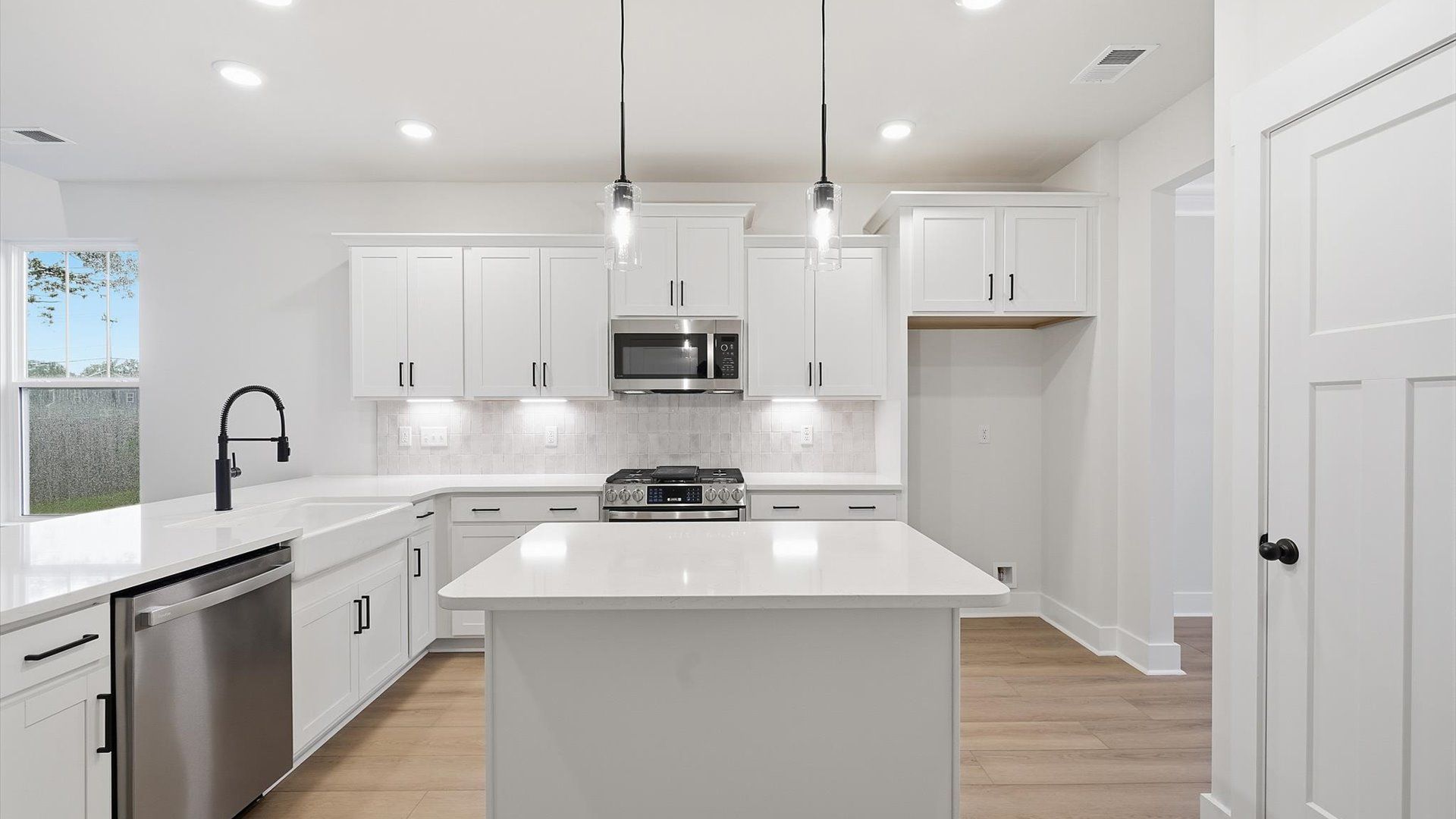 Highly functional kitchen offering a refined look and practical island at the center at the Barton Hollow community
