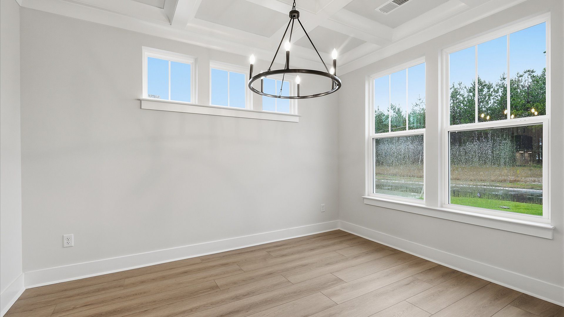 Eye-catching coffered ceiling adds charm to the formal dining space in this superior DRB Homes design