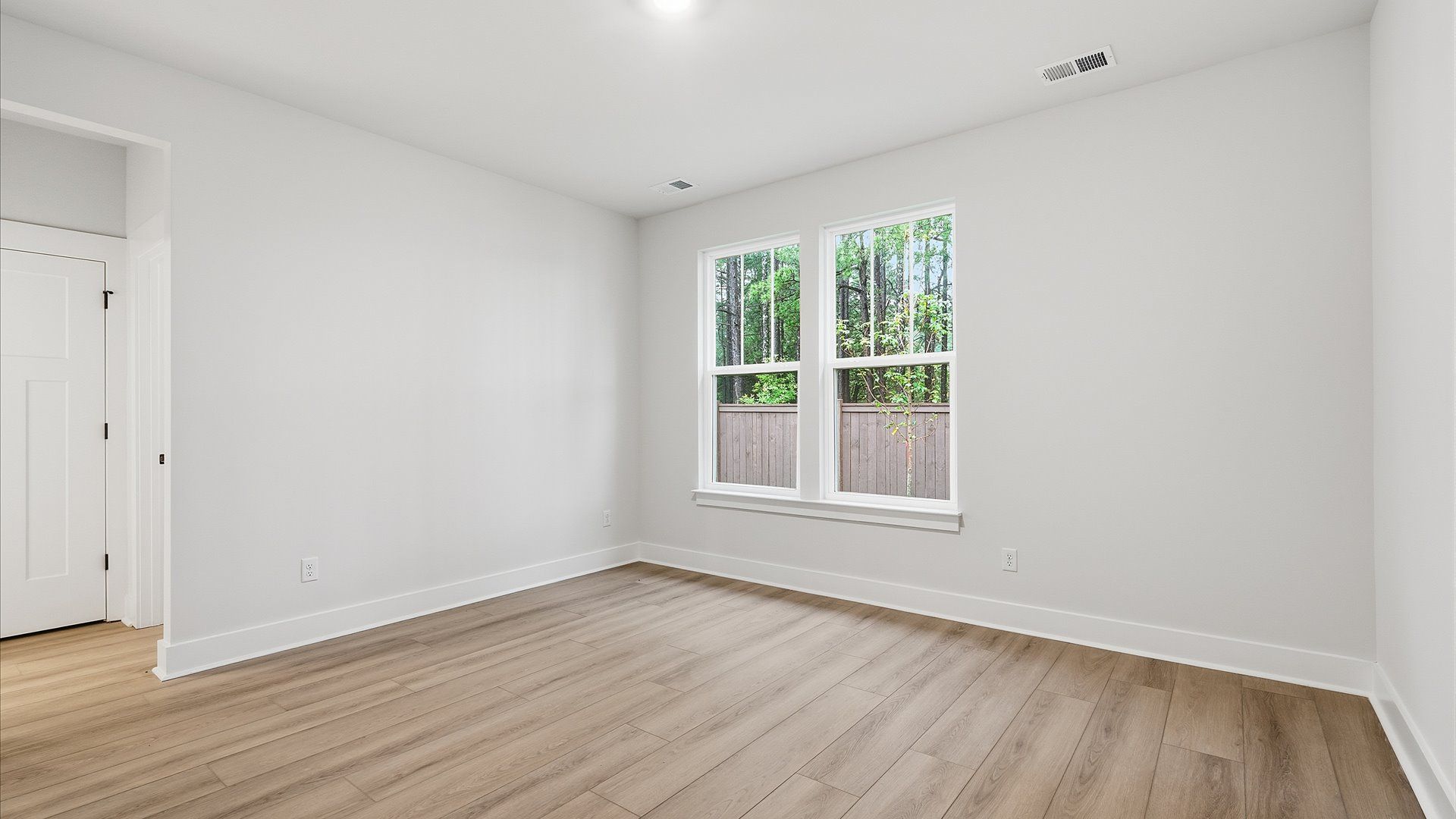 Accomplished primary retreat with eye-catching hardwood flooring in a desirable Fountain Inn community