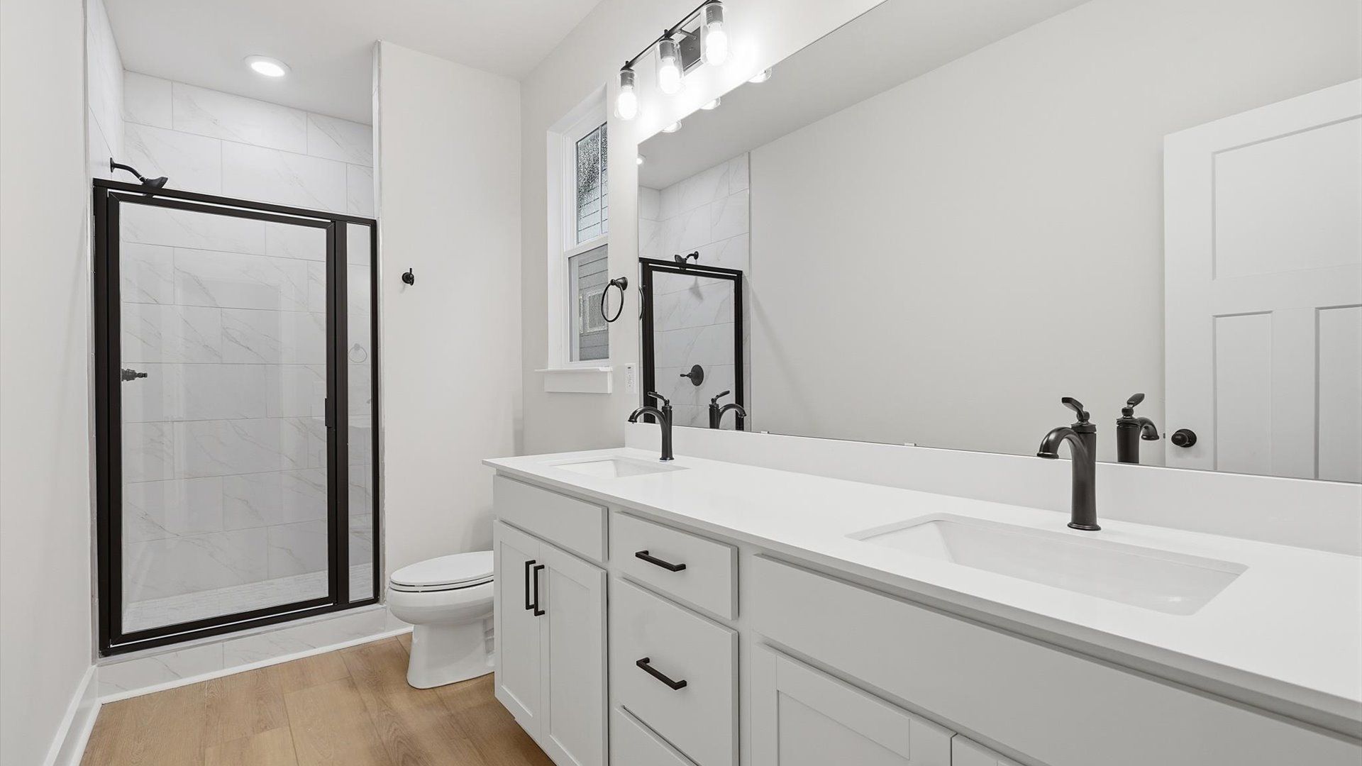 Memorable mornings begin in this elegant primary bathroom with walk-in shower and double vanity at Barton Hollow