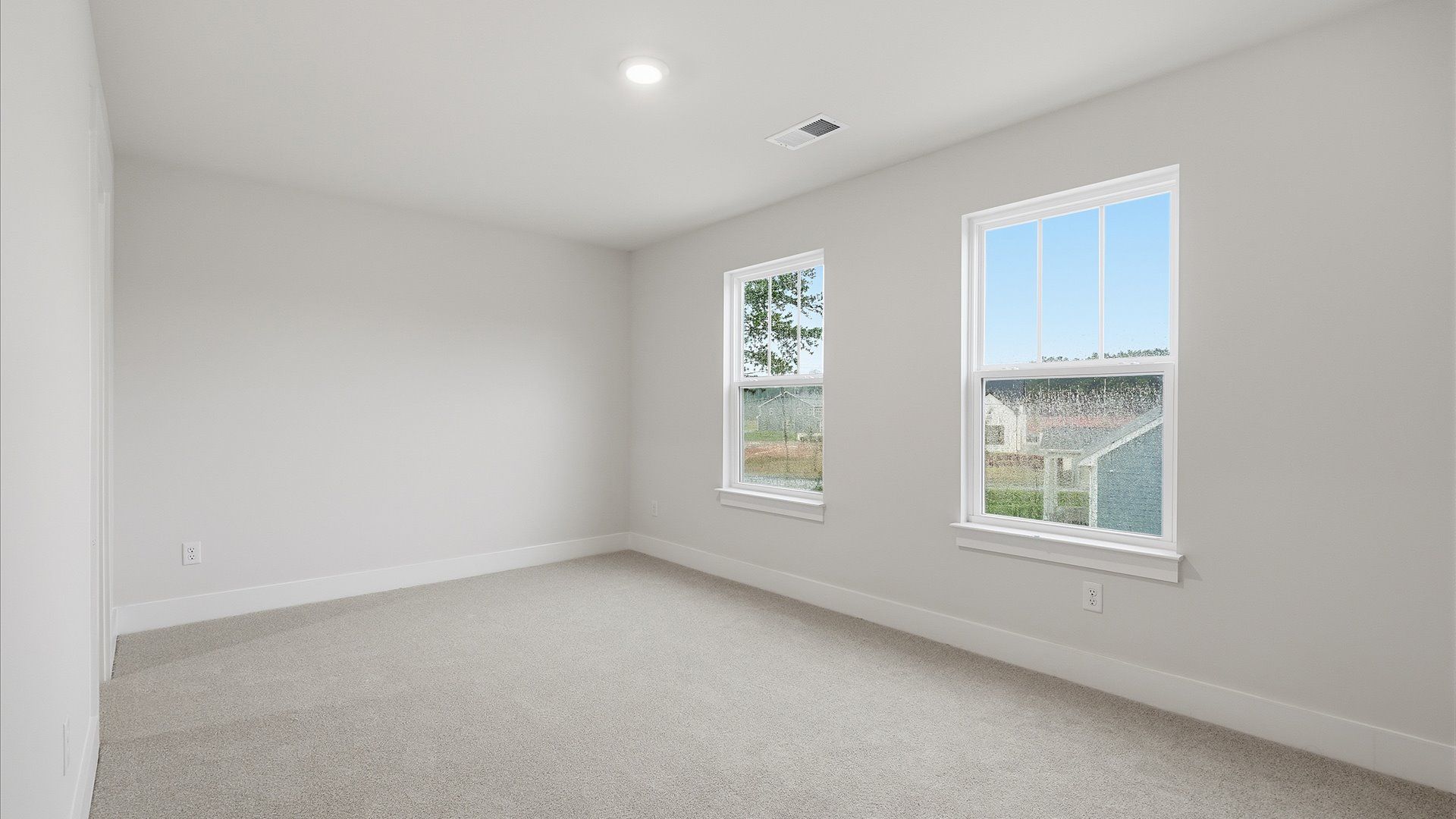 Notable bedroom offering soft carpet, a walk-in closet, and expansive windows overlooking the yard at Barton Hollow