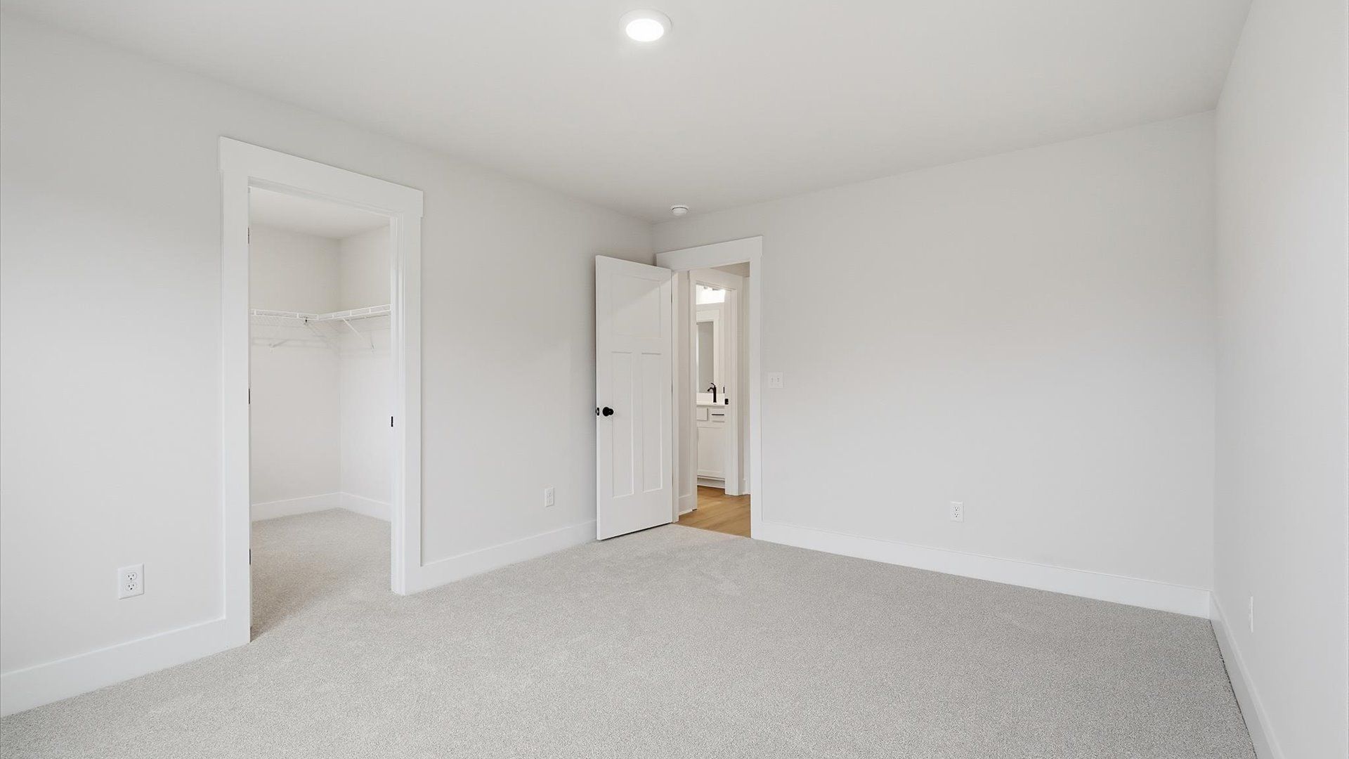 Vibrant and inviting secondary bedroom featuring a walk-in closet and refined finishes at the new Barton Hollow community