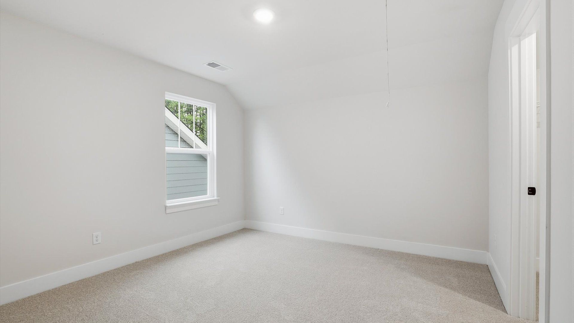 Vibrant and restful bedroom with oversized windows, refined detail, and a warm, welcoming atmosphere