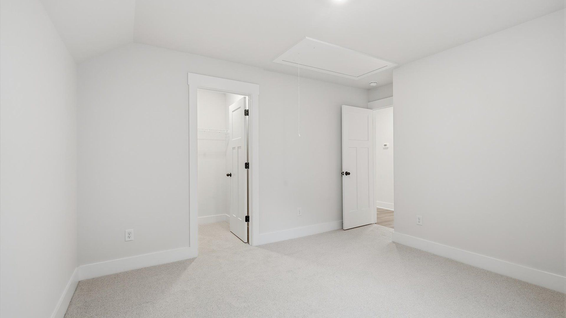 First-rate secondary bedroom with a spacious walk-in closet and elegant carpeted flooring at Barton Hollow