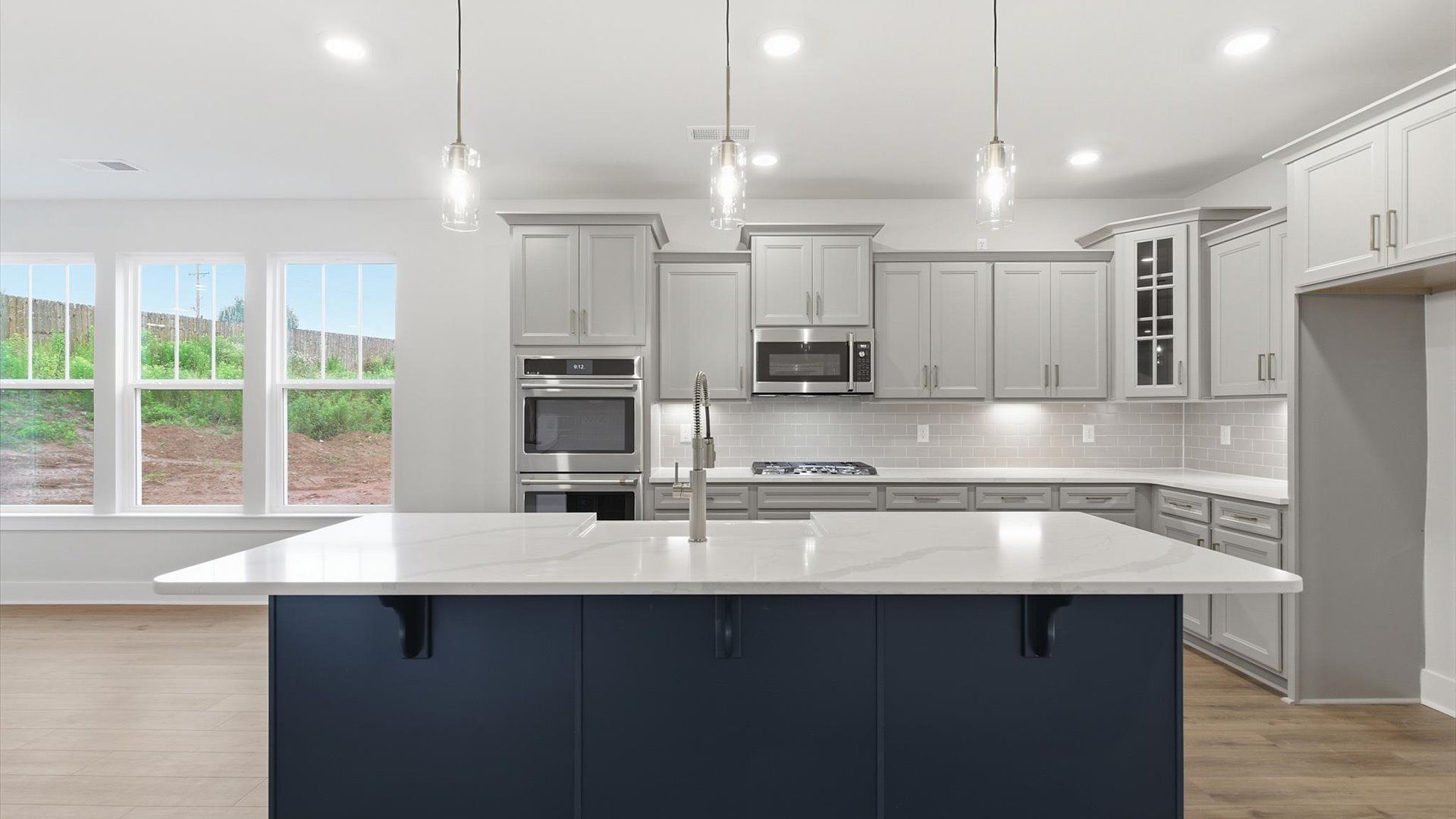 Exclusive kitchen design with large island, pendant lights, and tasteful finishes throughout in Piedmont, SC