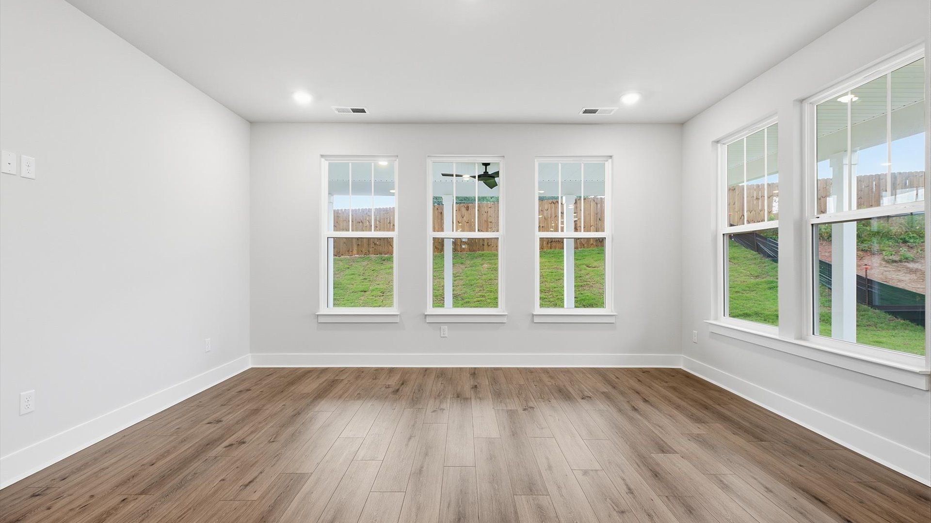 Vibrant and welcoming family room anchored by clean lines, tasteful materials, and abundant light by DRB Homes