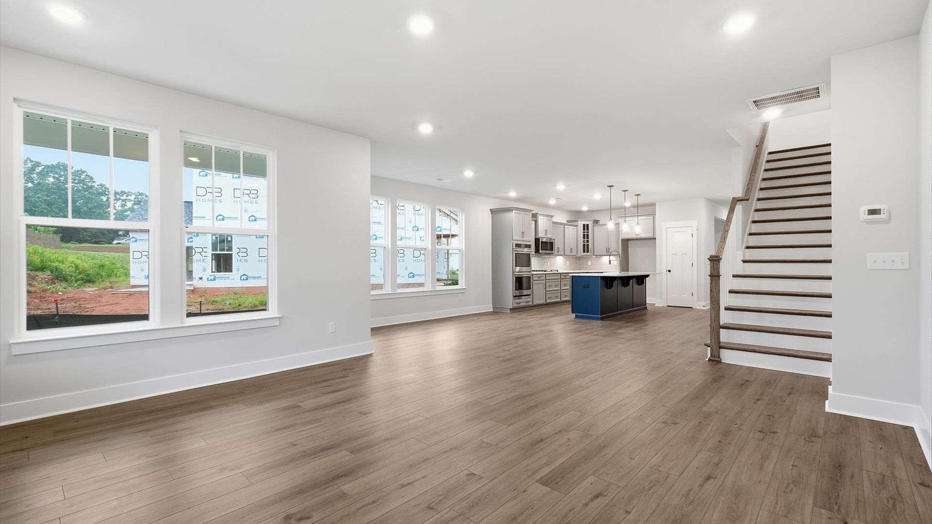 Hardwood flooring and high standards define this vibrant family room ideal for everyday living at a reputable community