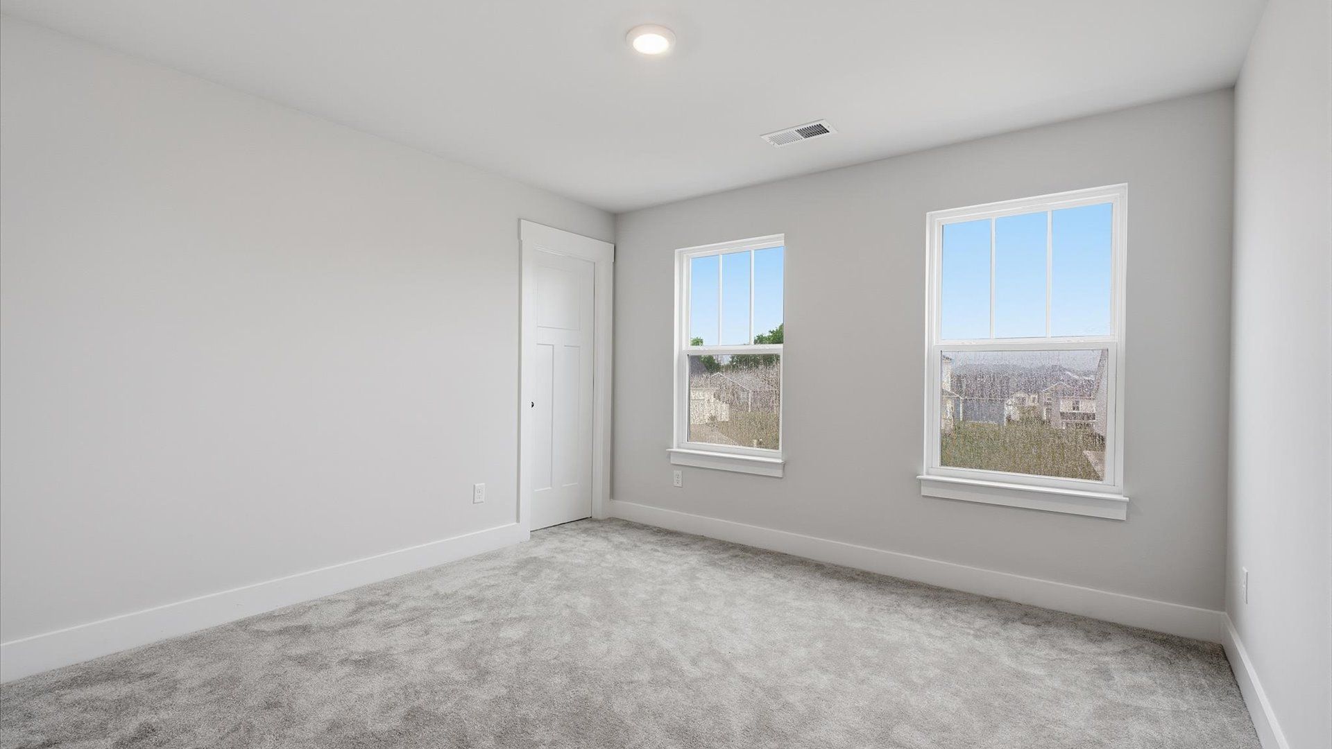 Memorable bedroom space offering plush carpet underfoot and a thoughtfully planned walk-in closet at Woodglen
