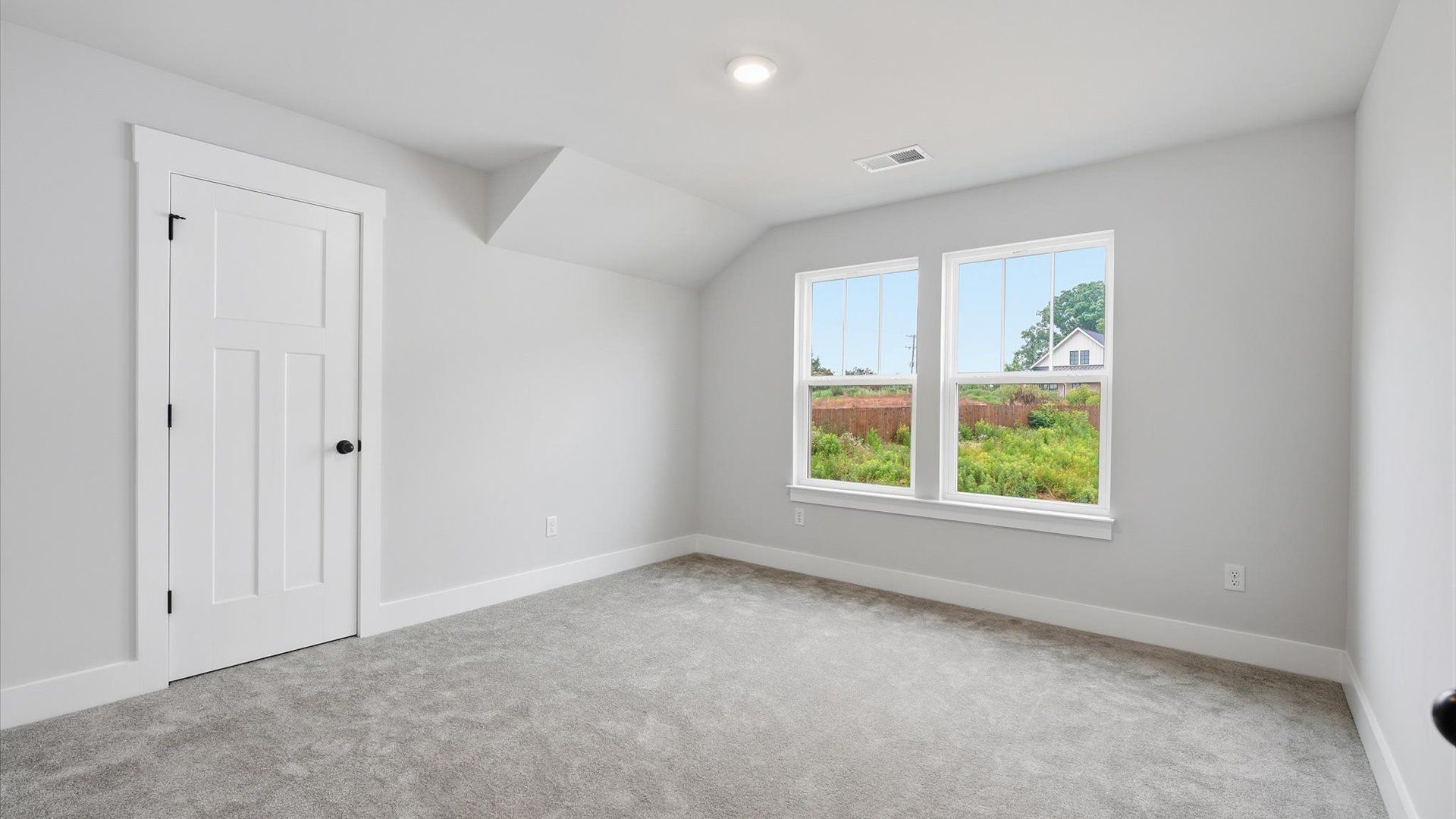 First-class bedroom with generous proportions, a walk-in closet, and beautiful natural light through large windows