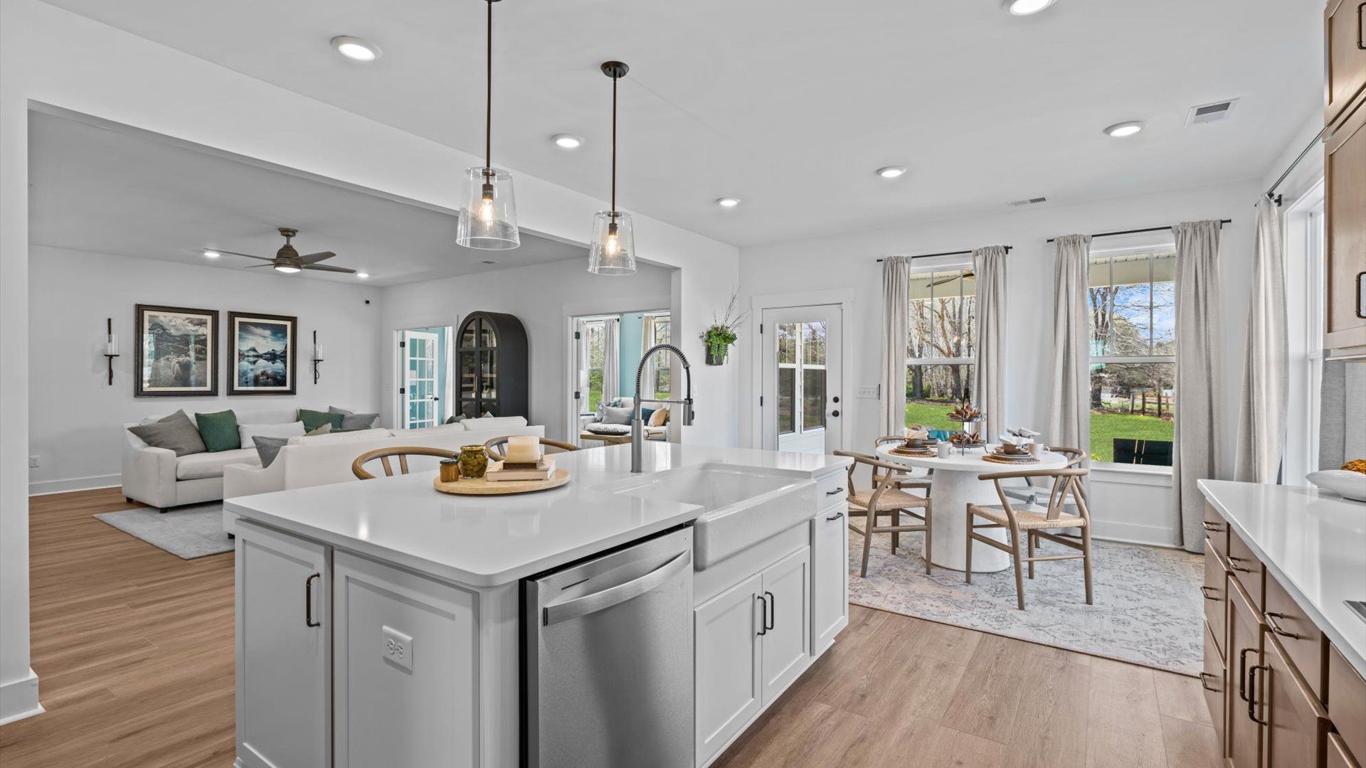 Kitchen with open sightlines, quartz countertops, and stainless steel appliances at the Pinebrook community