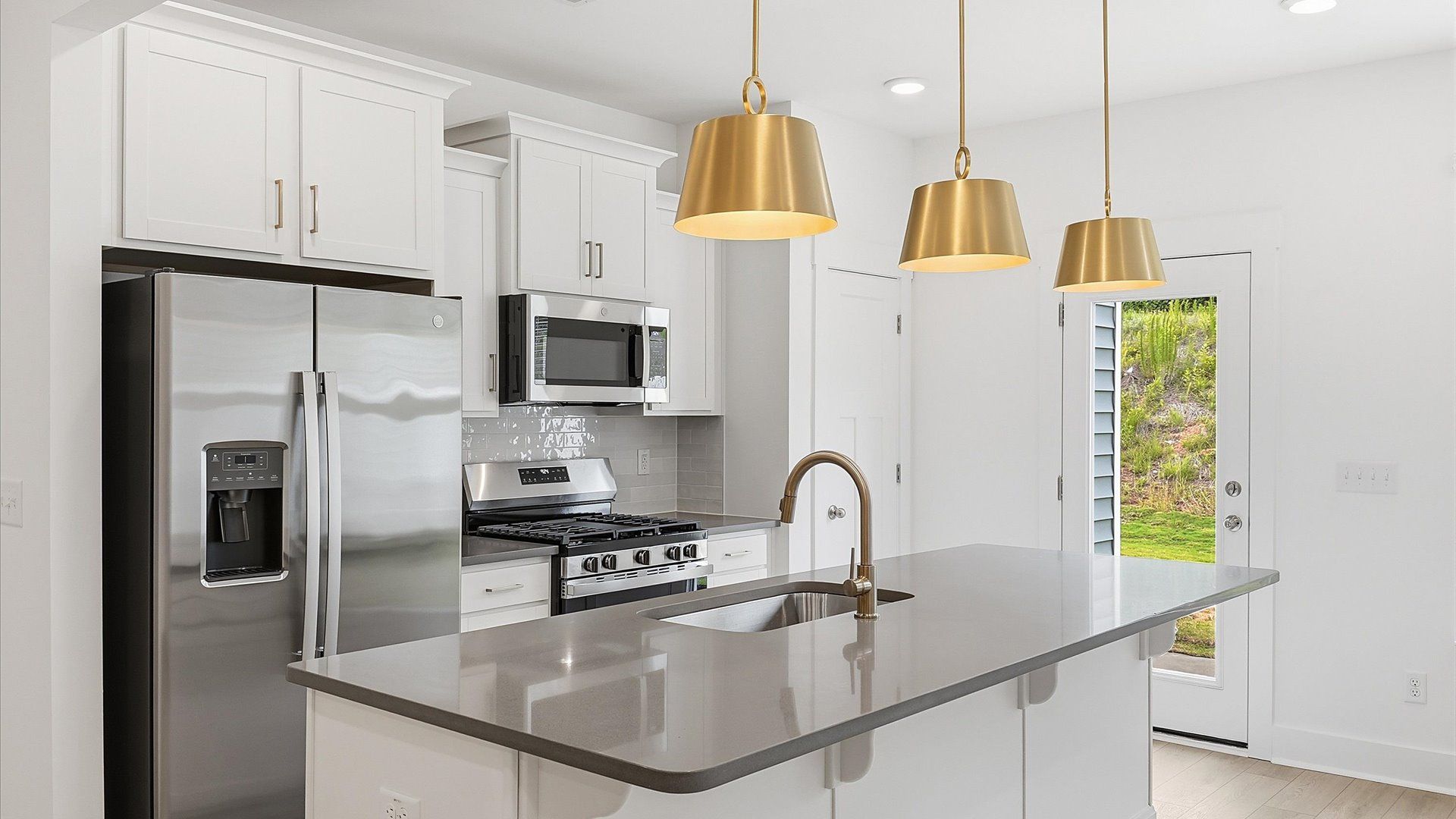 Tasteful kitchen with a streamlined island and modern finishes in a first-class DRB Homes design