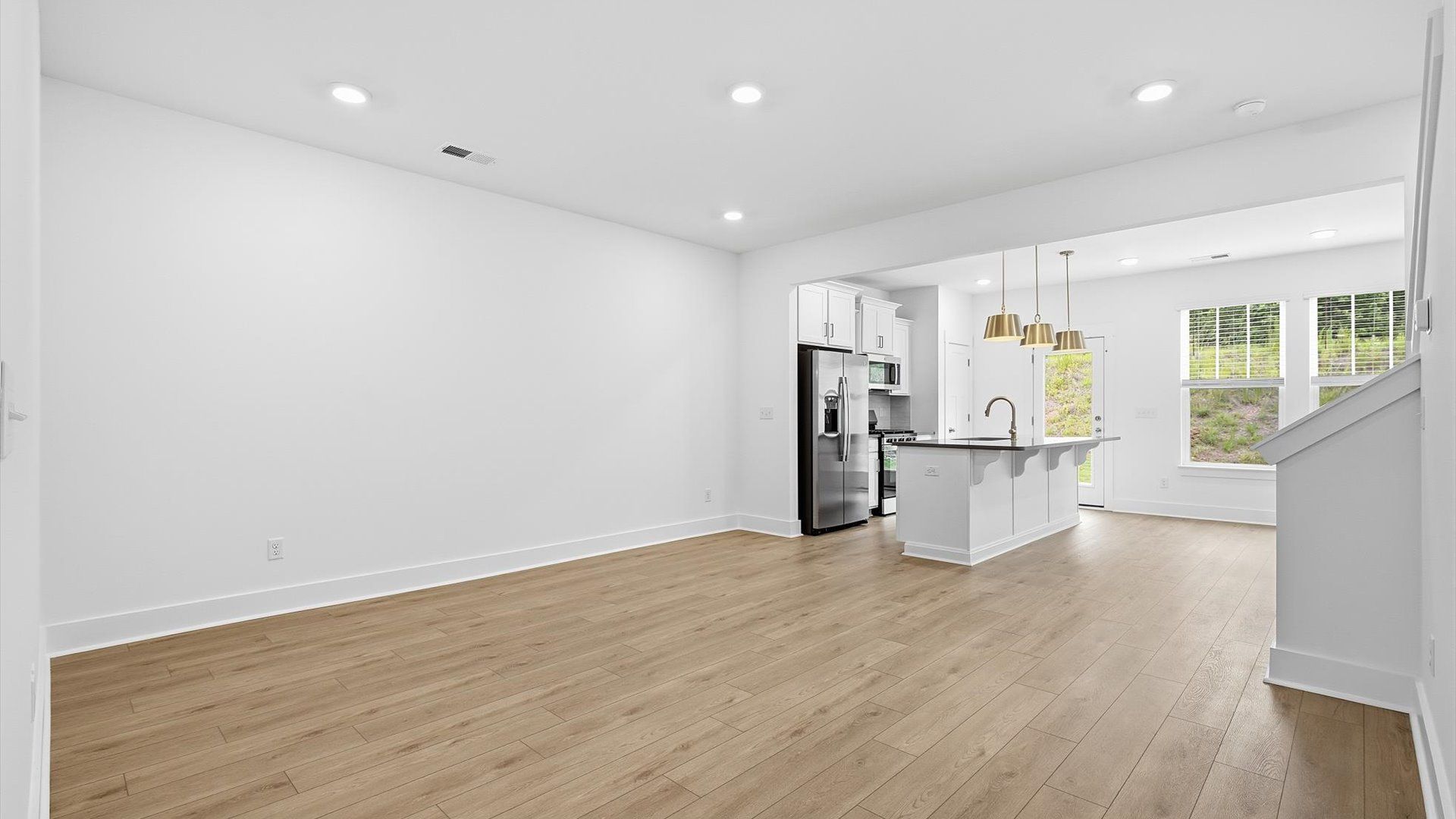 Hardwood flooring and high standards define this vibrant family room ideal for everyday living by DRB Homes