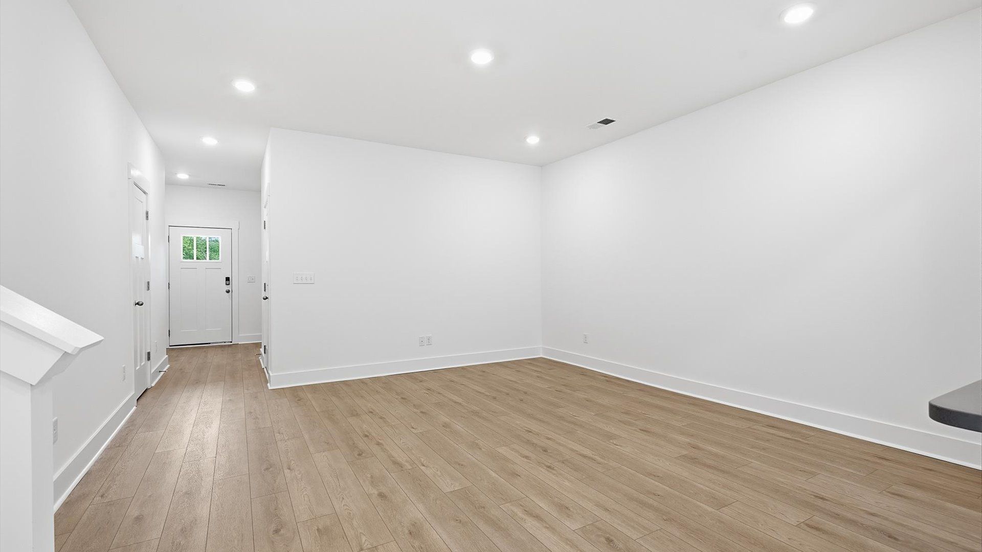 Elegant family room featuring hardwood flooring and thoughtful architectural detail at the new Marion Square community