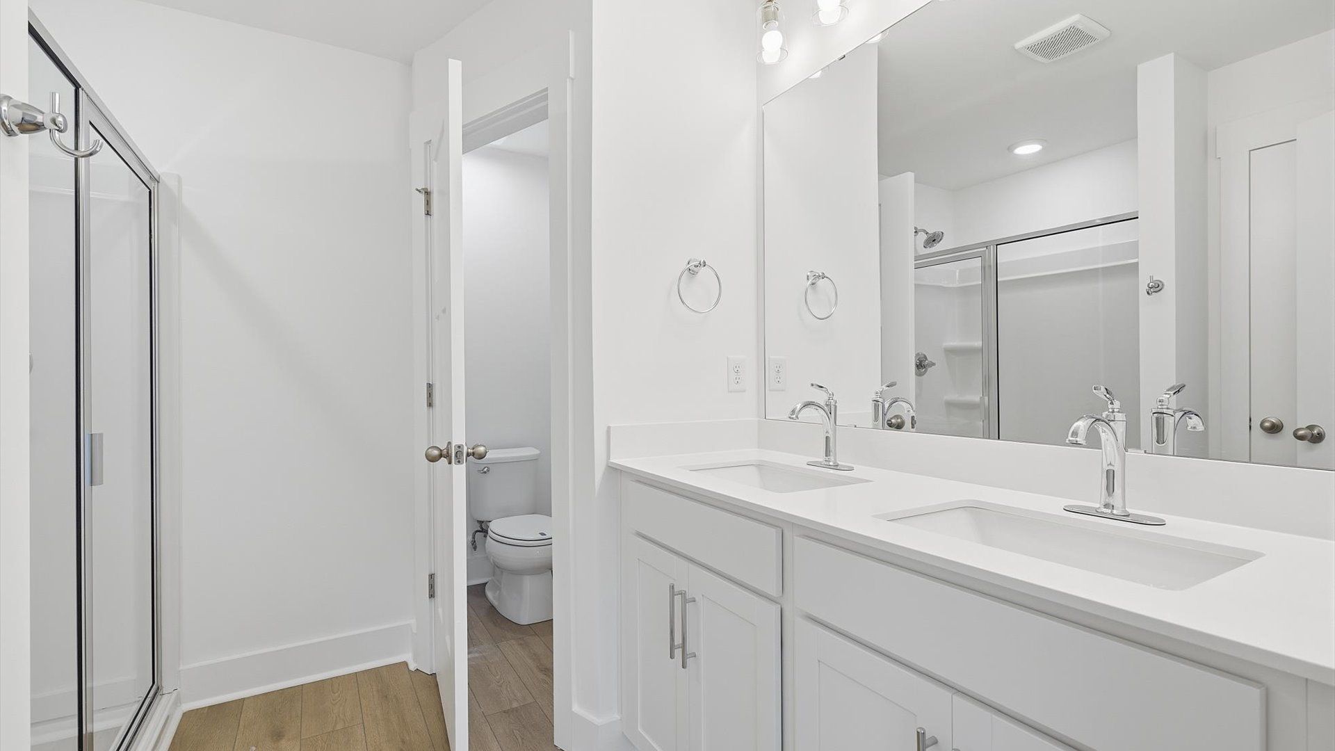 Memorable mornings begin in this elegant primary bathroom with walk-in shower and double vanity in Greenville, SC