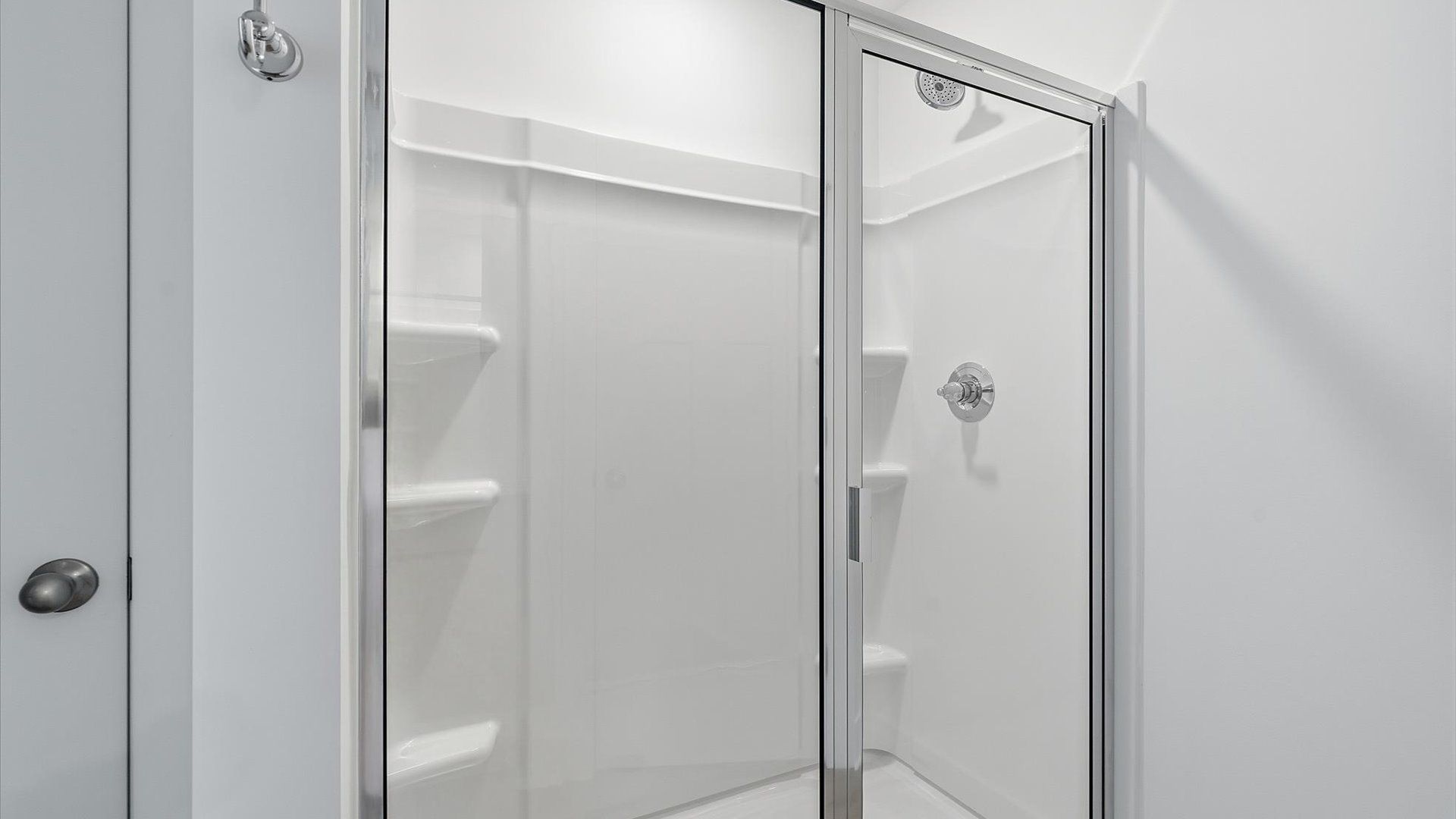 Exceptional en-suite with dual vanity and glass-enclosed walk-in shower for superior everyday comfort