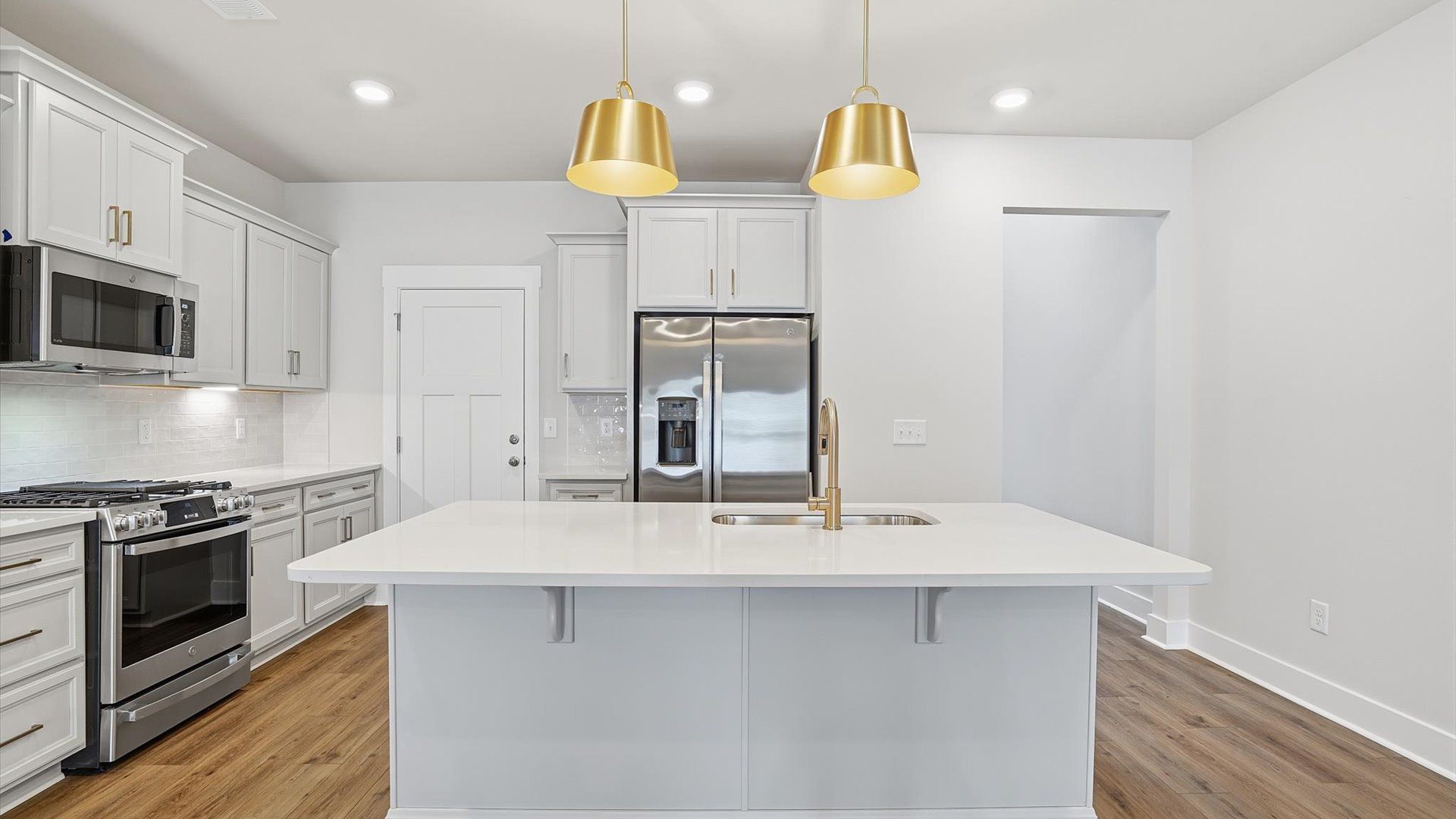 First-rate kitchen with a smaller island and superior cabinetry in a thoughtfully designed space at Village at Midway