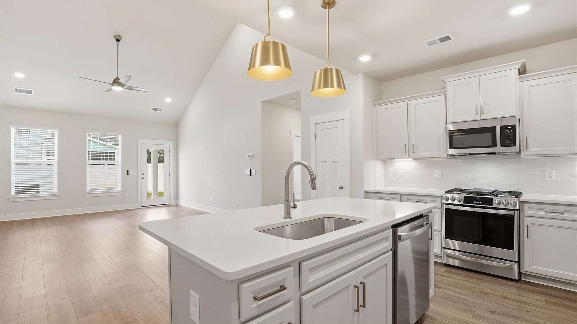 Bright and airy culinary space with generous prep areas and contemporary lighting at Village at Midway