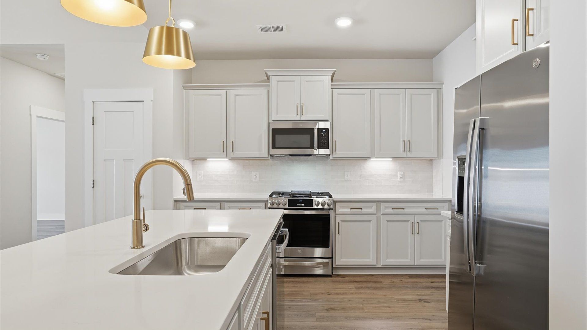 Memorable meals begin in this vibrant kitchen with pendant lighting and a thoughtfully designed island by DRB Homes