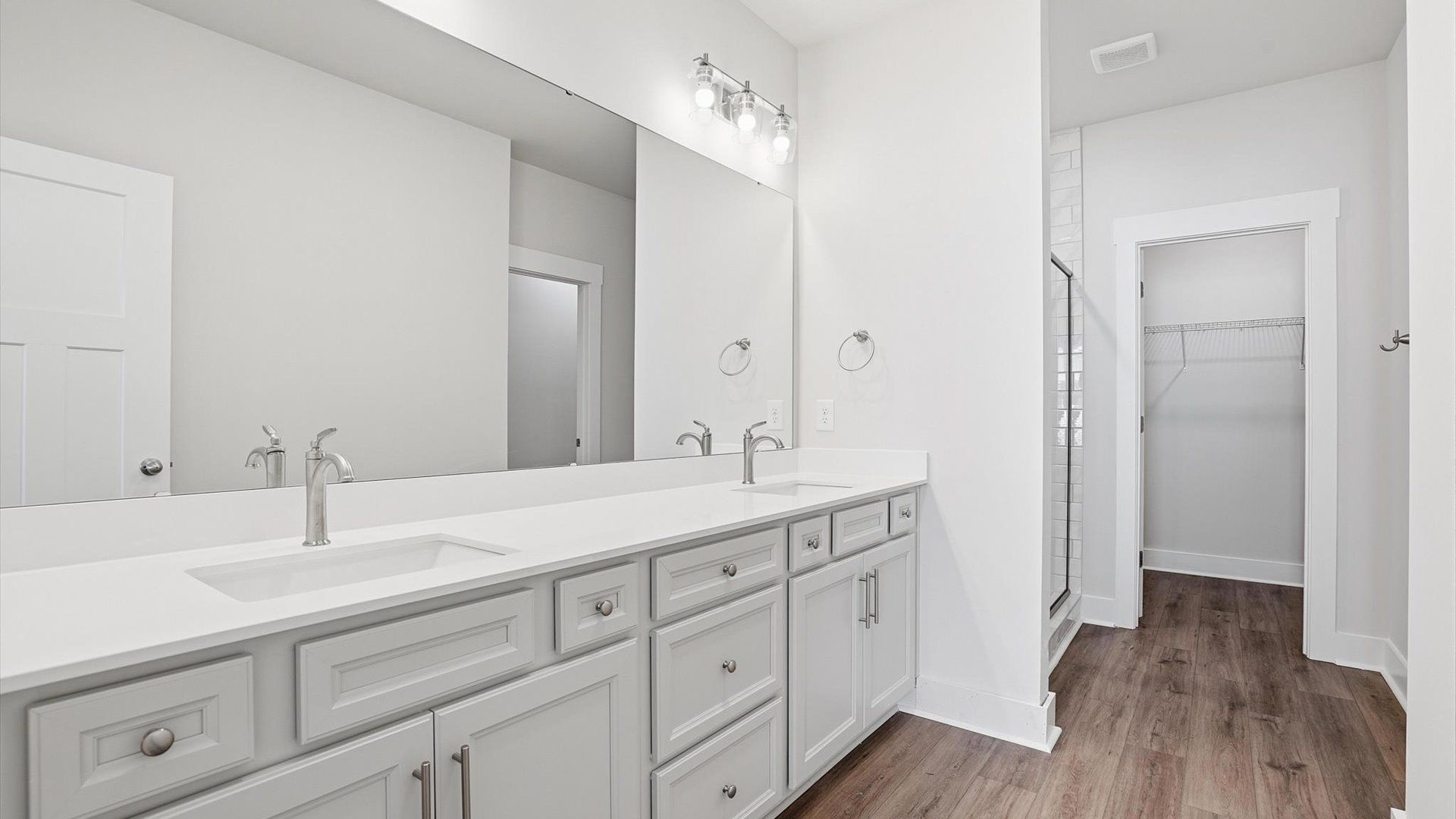 Exceptional en-suite with dual vanity and glass-enclosed walk-in shower for superior everyday comfort
